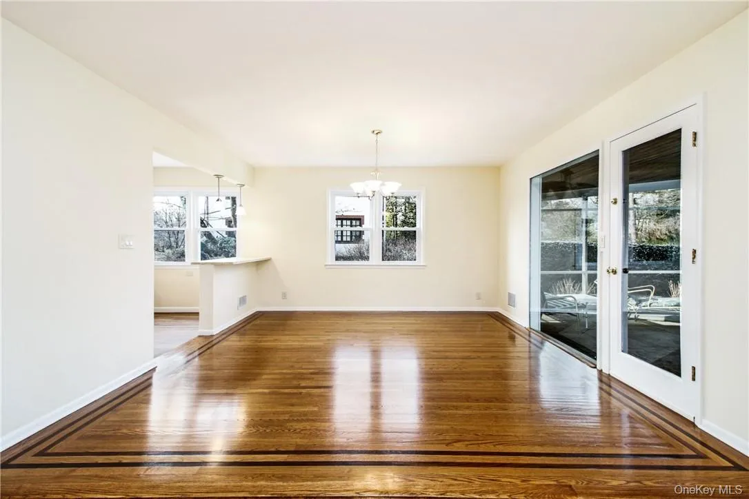 Spacious dining area with detailed oak. Photos taken when house was empty prior to occupancy. floors, access to kitchen and covered screened porch Spacious dining area with detailed oak. Photos taken when house was empty prior to occupancy. floors, access to kitchen and covered screened porch