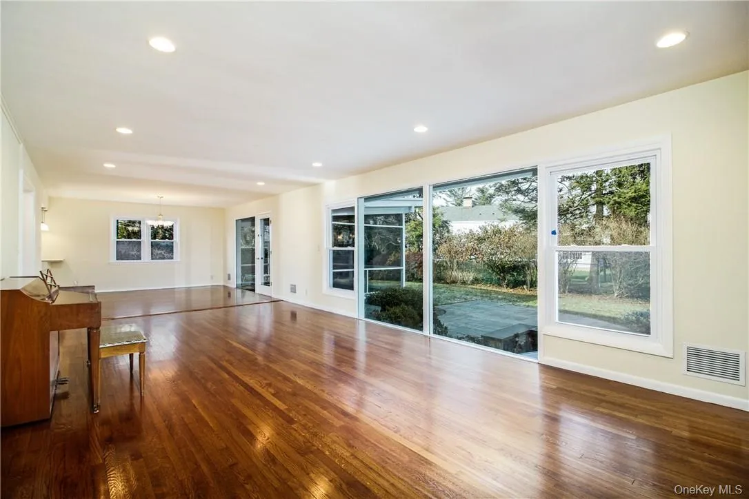 View of great room facing dining area and covered screened porch. Photos taken when house was empty prior to occupancy. View of great room facing dining area and covered screened porch. Photos taken when house was empty prior to occupancy.
