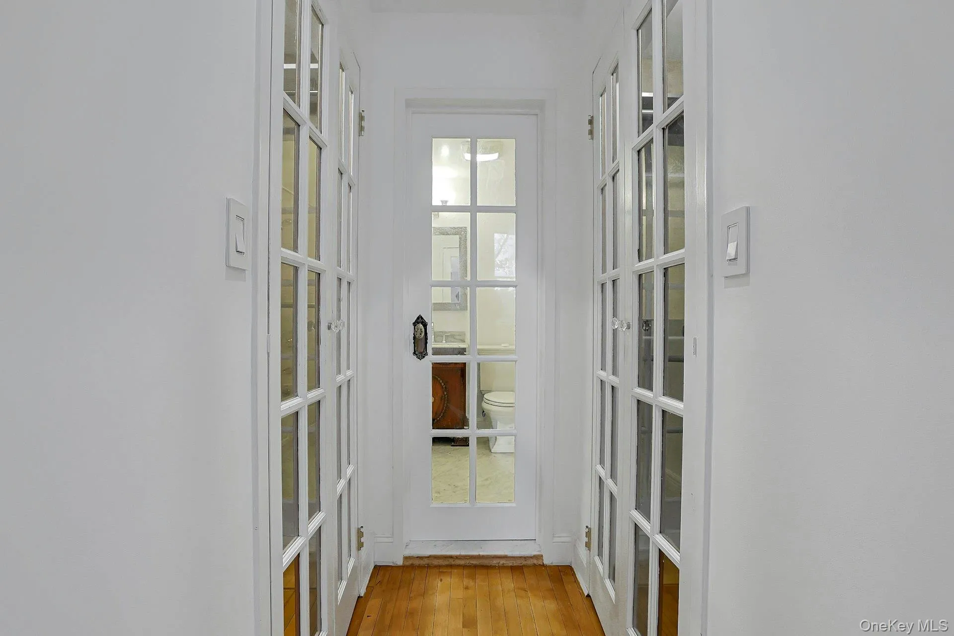 View into primary bathroom with 2 custom closets. View into primary bathroom with 2 custom closets.