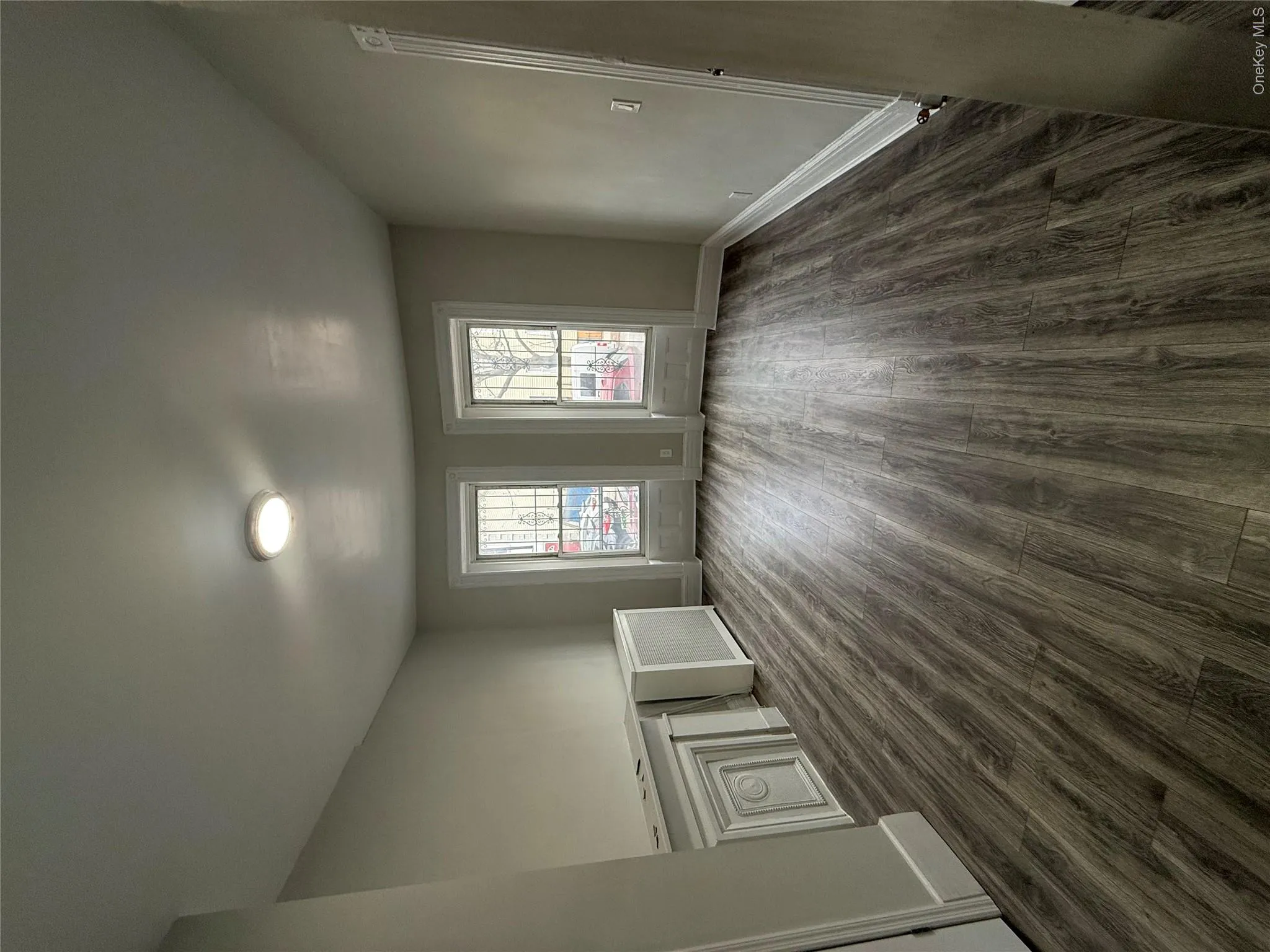Unfurnished room featuring dark wood finished floors and radiator Unfurnished room featuring dark wood finished floors and radiator