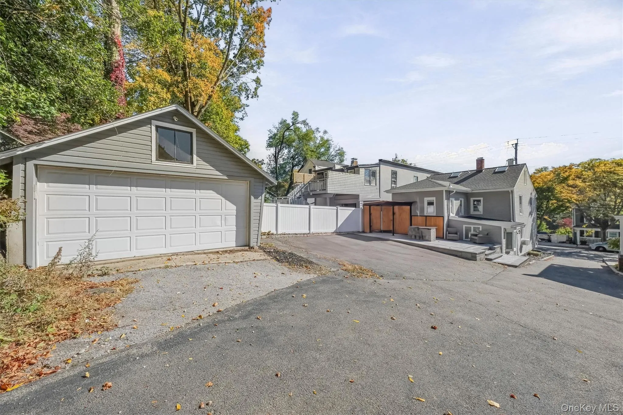 Exceptional property layout featuring a detached 2-car garage, expansive driveway parking for up to 4 additional vehicles, and a custom outdoor kitchen setup. Exceptional property layout featuring a detached 2-car garage, expansive driveway parking for up to 4 additional vehicles, and a custom outdoor kitchen setup.