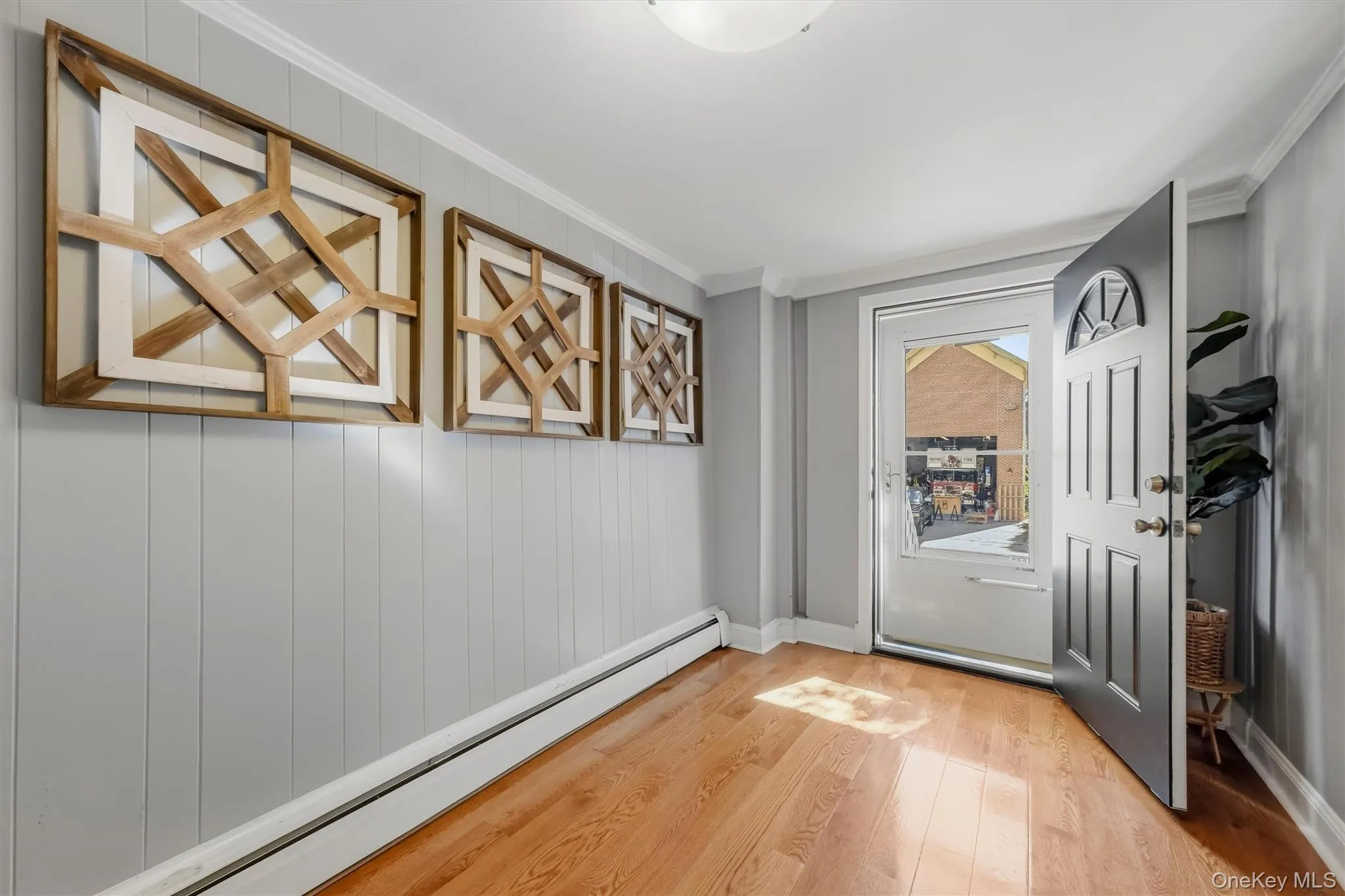 Alternate angle of the welcoming foyer and hallway area showing seamless flow into the home. Alternate angle of the welcoming foyer and hallway area showing seamless flow into the home.