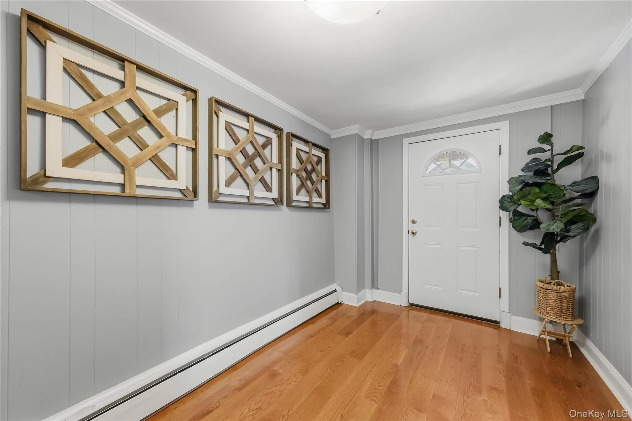 Bright and welcoming interior foyer featuring gleaming hardwood floors and crisp neutral tones. Bright and welcoming interior foyer featuring gleaming hardwood floors and crisp neutral tones.