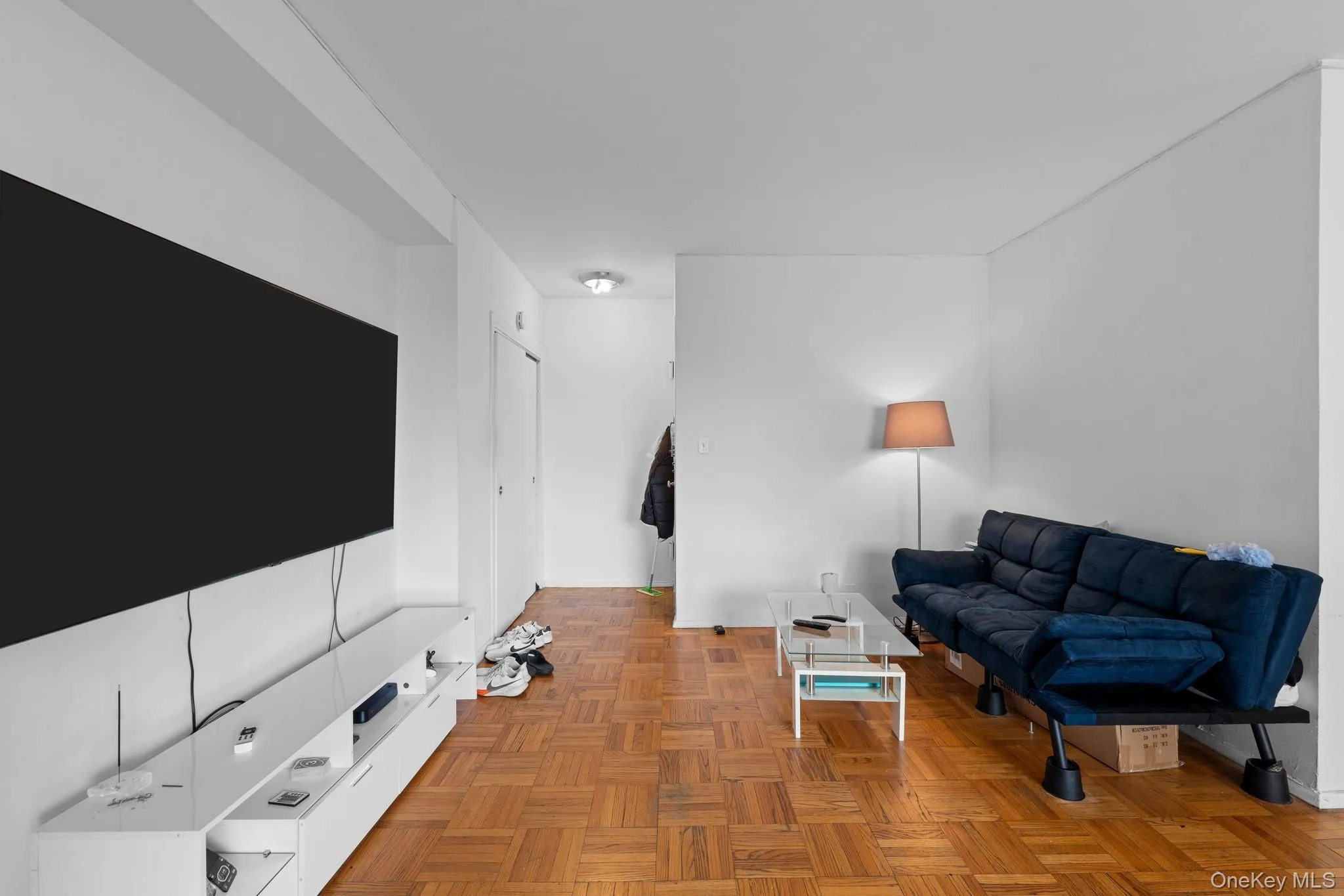 Wood-finish parquet flooring, white walls, and recessed lighting Wood-finish parquet flooring, white walls, and recessed lighting