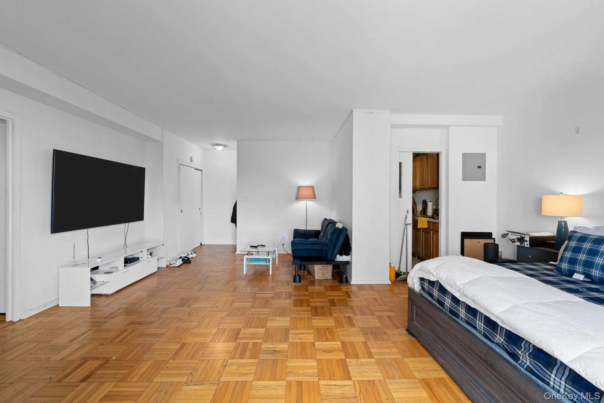 Parquet wood-finish flooring, white walls, and recessed lighting Parquet wood-finish flooring, white walls, and recessed lighting