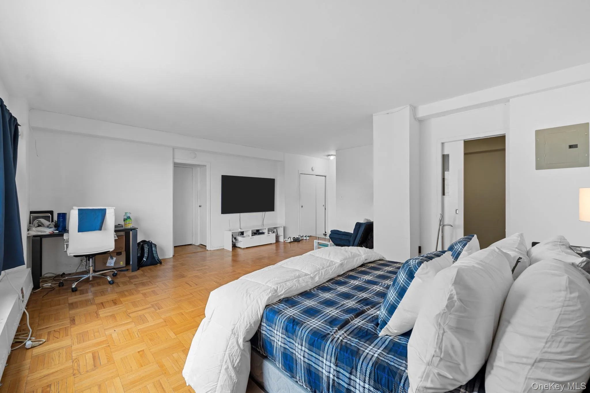 Hardwood parquet flooring, neutral wall tones, recessed lighting, and a sliding door Hardwood parquet flooring, neutral wall tones, recessed lighting, and a sliding door