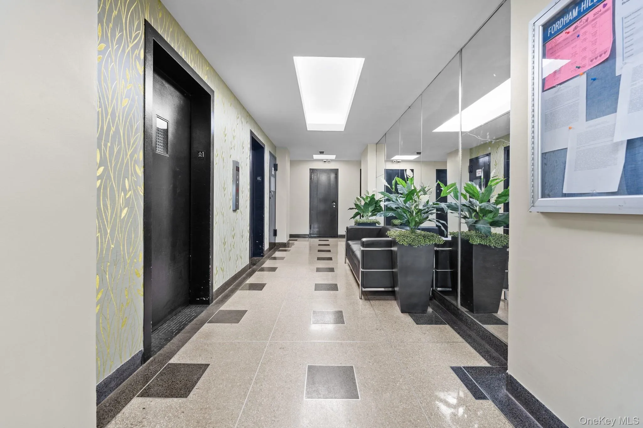 Hallway with patterned wallpaper, tile flooring, and integrated ceiling lighting Hallway with patterned wallpaper, tile flooring, and integrated ceiling lighting