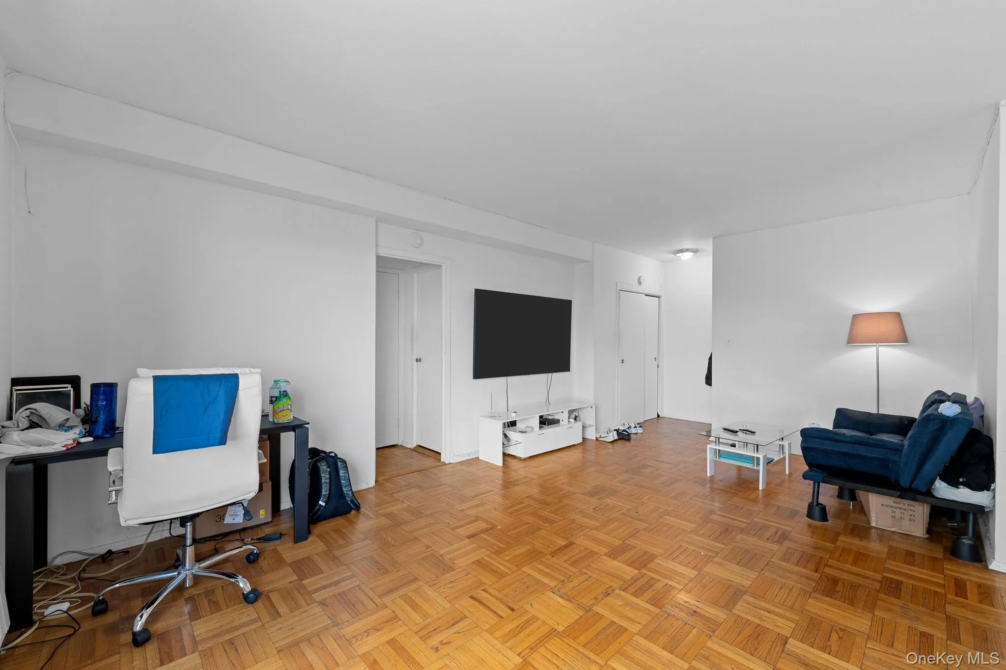 Parquet flooring, white walls, and a recessed ceiling light Parquet flooring, white walls, and a recessed ceiling light