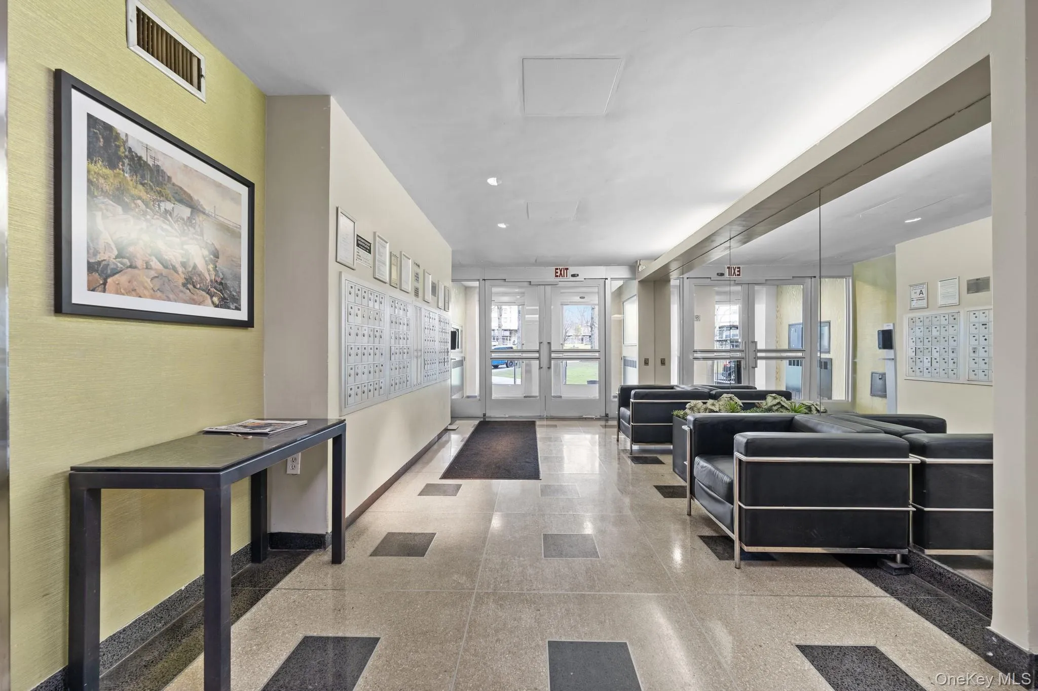 Shared common area featuring large format floor tiling, a mirrored wall, and built-in mailboxes Shared common area featuring large format floor tiling, a mirrored wall, and built-in mailboxes
