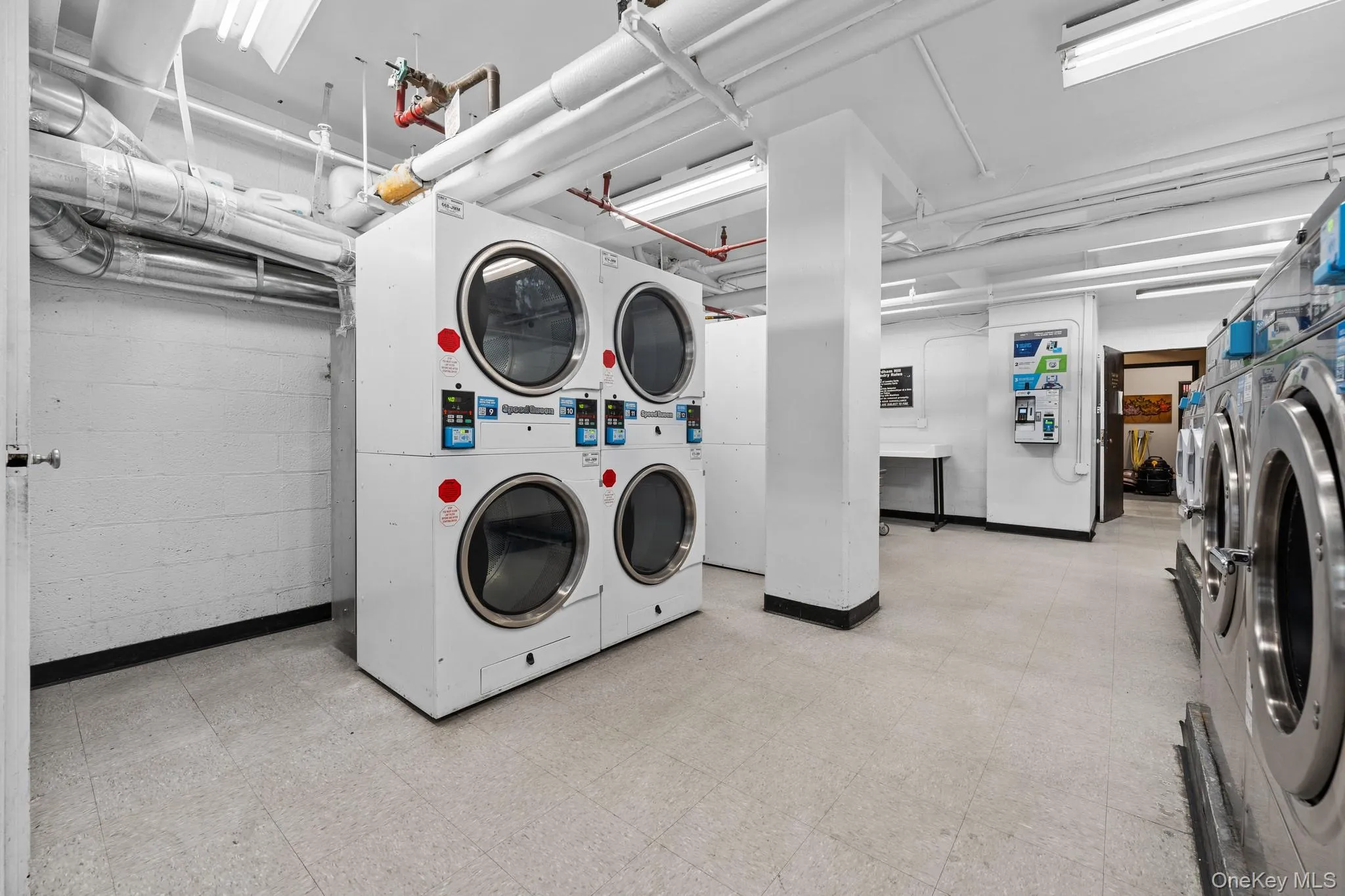 Dedicated laundry facility featuring multiple commercial-grade washer and dryer units Dedicated laundry facility featuring multiple commercial-grade washer and dryer units