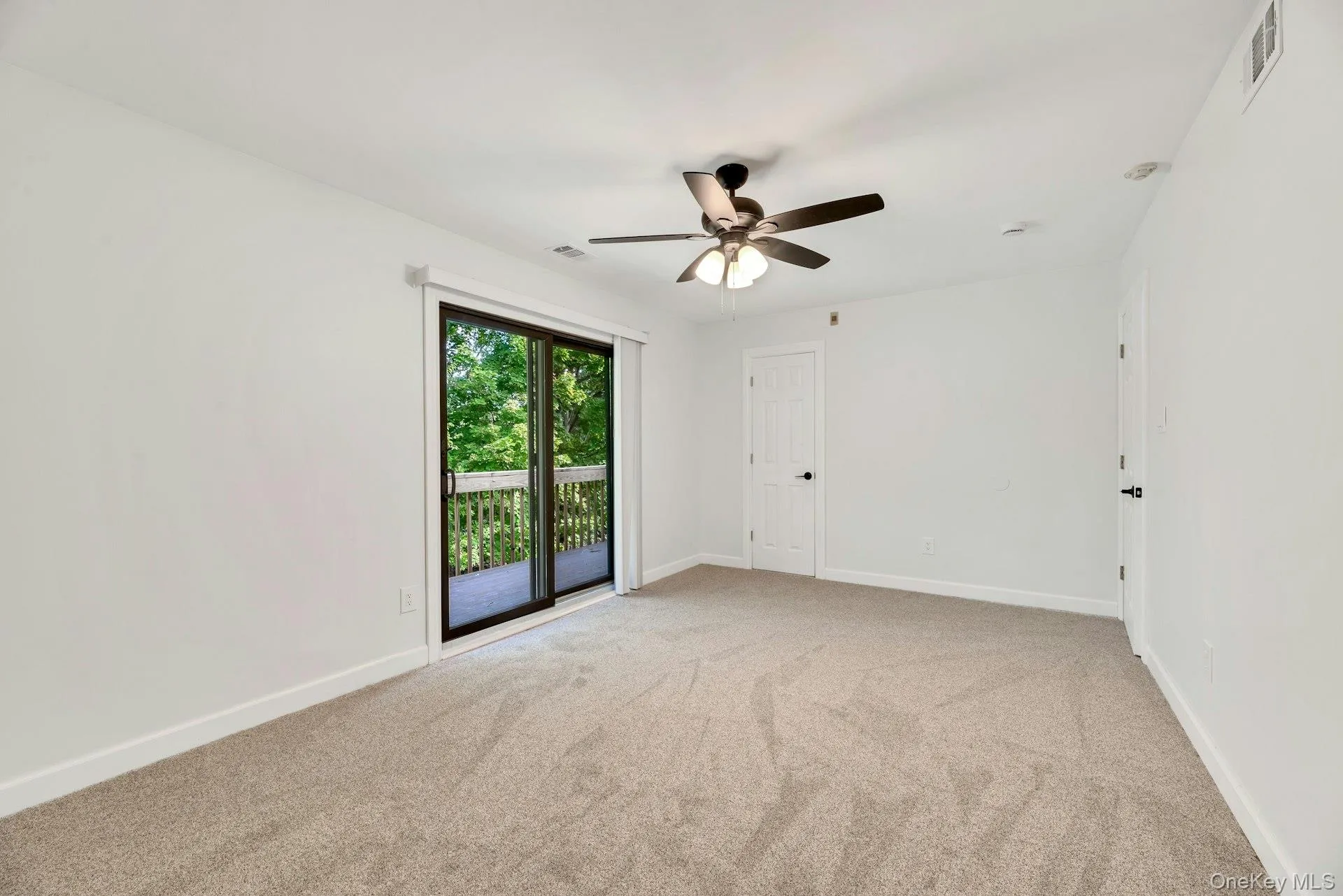 Bedroom with sliding doors and large closet. Bedroom with sliding doors and large closet.