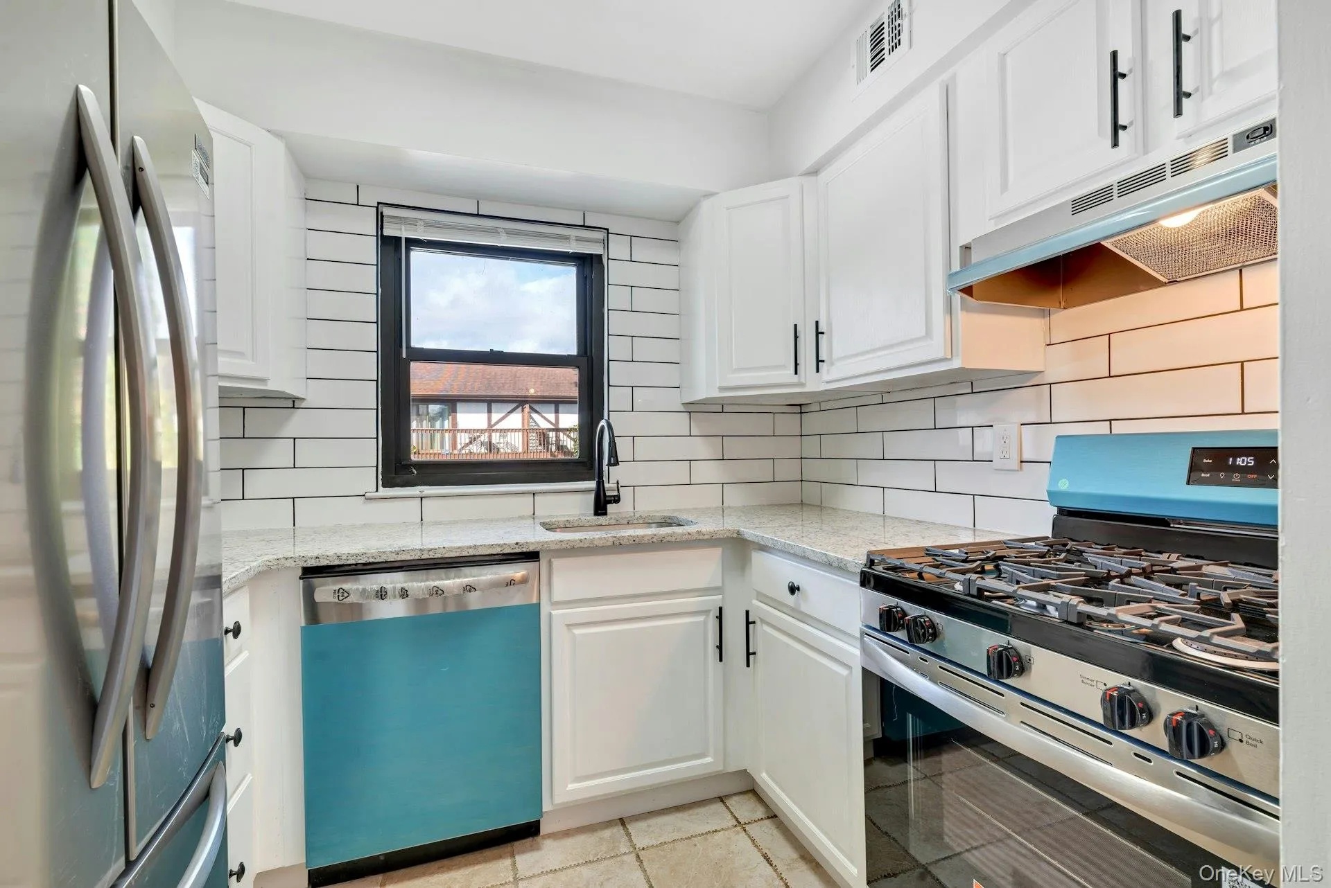 Kitchen with new Stainless Steel Appliances, Backsplash, and Window over Sink. Kitchen with new Stainless Steel Appliances, Backsplash, and Window over Sink.