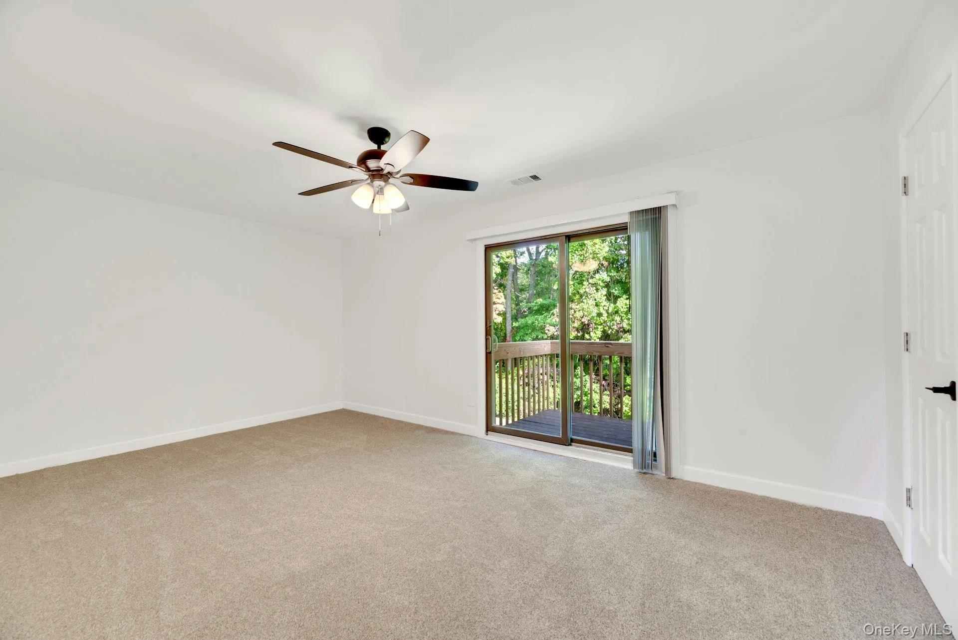 Bedroom with sliding doors to rear deck. Bedroom with sliding doors to rear deck.