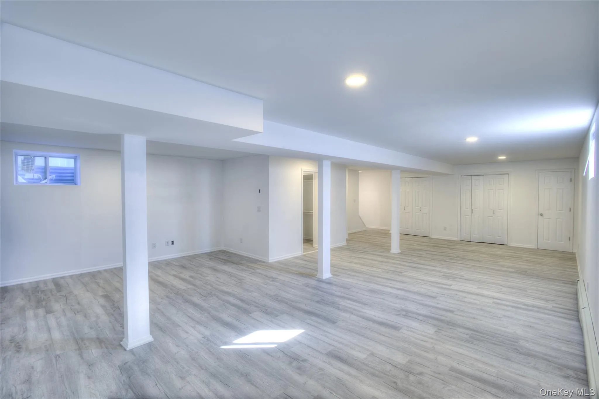 Renovated 2026 -FULL FINISHED BASEMENT ABUNDANT STORAGE!!Spacious room with wood-finish flooring, recessed ceiling lights, and multiple windows Renovated 2026 -FULL FINISHED BASEMENT ABUNDANT STORAGE!!Spacious room with wood-finish flooring, recessed ceiling lights, and multiple windows