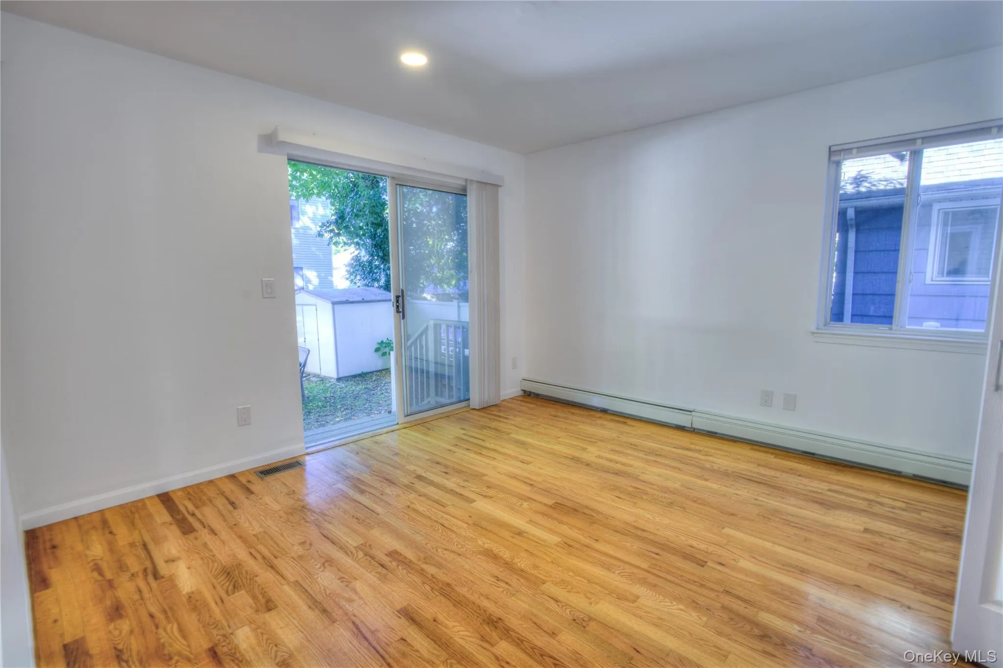 Renovated 2026 Wood-finish flooring, recessed lighting, and a sliding glass door to the exterior Renovated 2026 Wood-finish flooring, recessed lighting, and a sliding glass door to the exterior