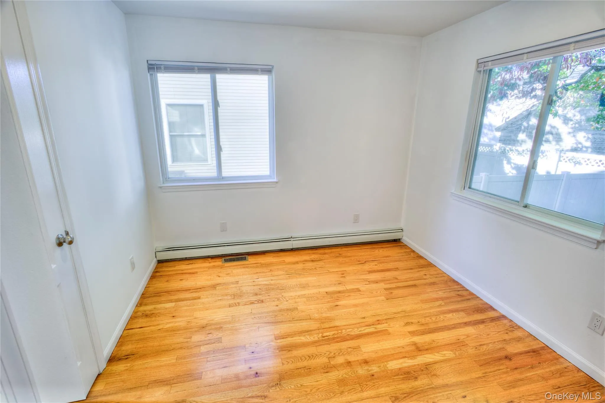 Hardwood flooring, white painted walls, and white trim Hardwood flooring, white painted walls, and white trim