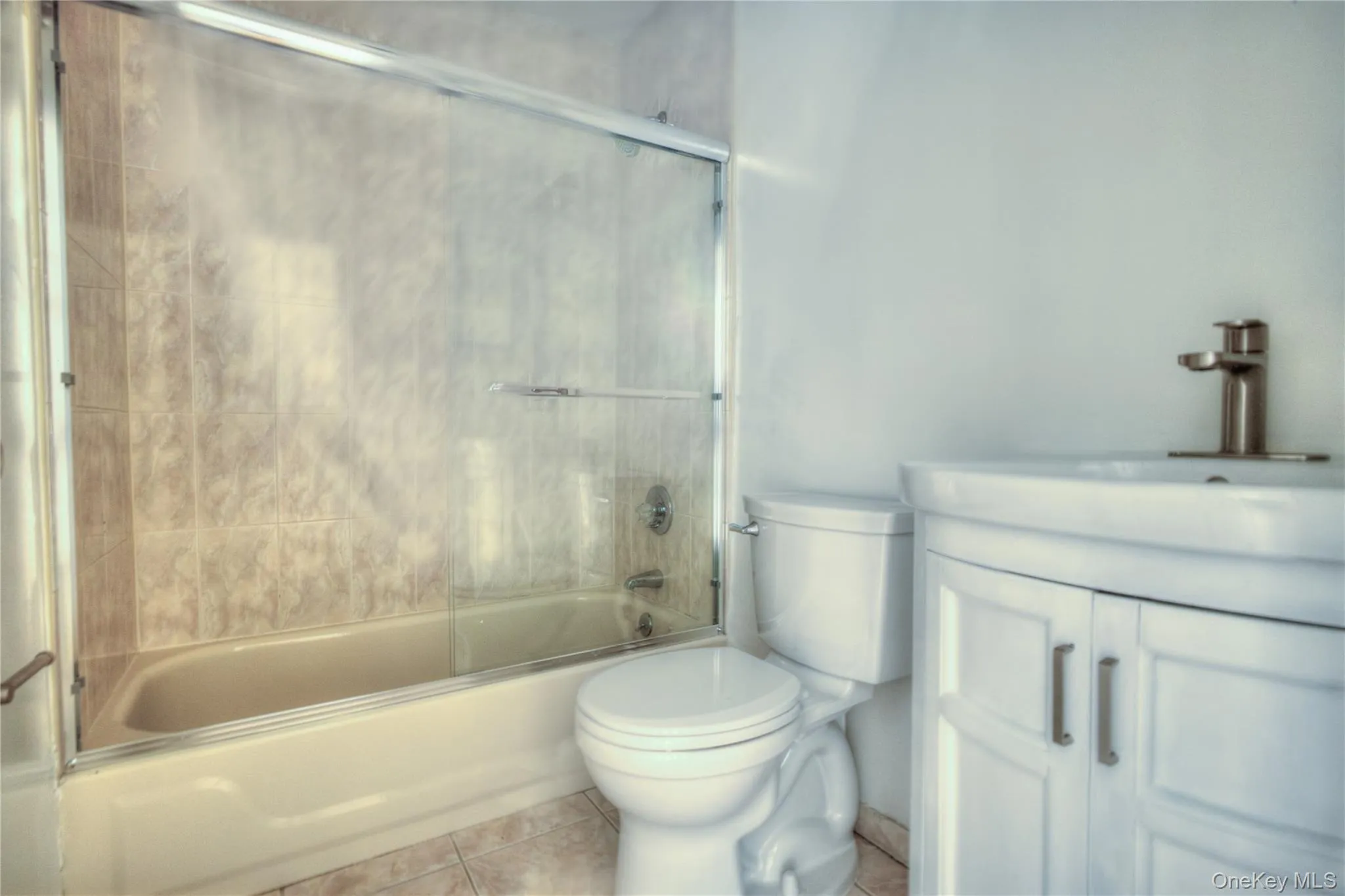 Renovated 2026 -White vanity with brushed nickel hardware, integrated sink, and brushed nickel faucet Renovated 2026 -White vanity with brushed nickel hardware, integrated sink, and brushed nickel faucet
