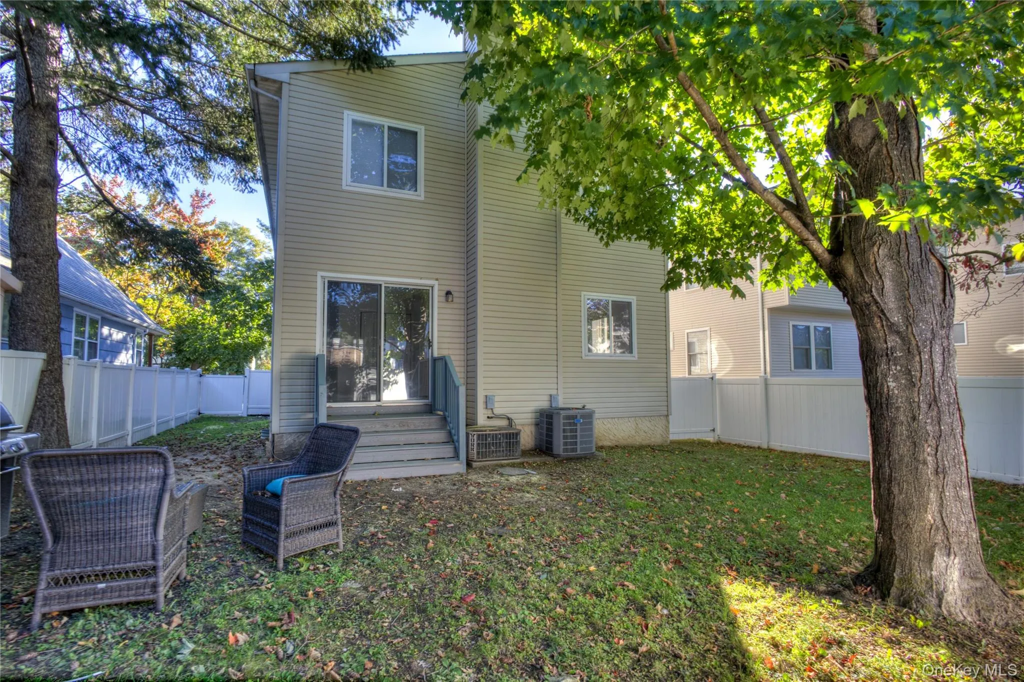Vinyl siding exterior featuring multiple windows and a sliding glass door Vinyl siding exterior featuring multiple windows and a sliding glass door