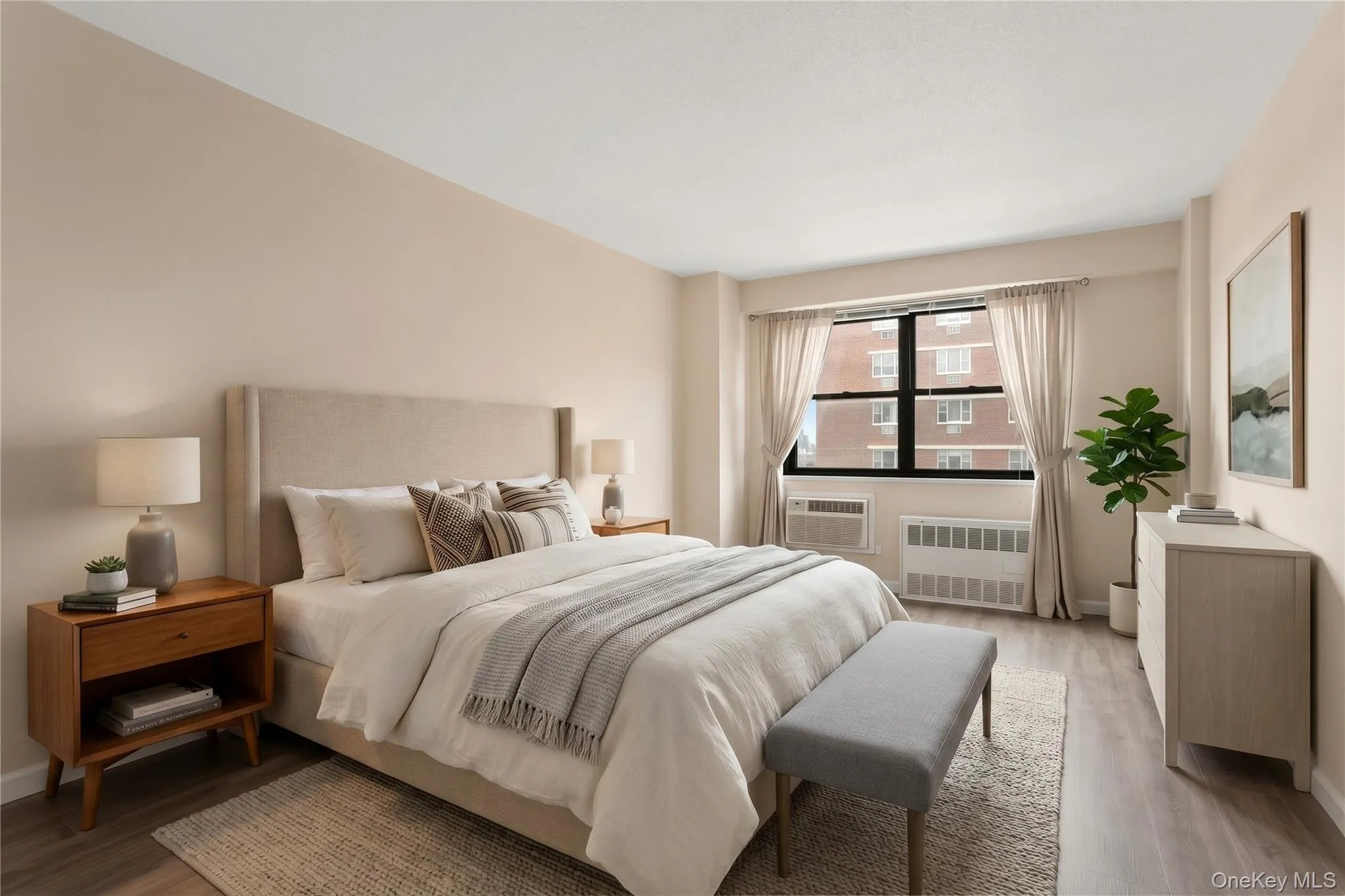 Large bedroom with oversized windows and hardwood floors Large bedroom with oversized windows and hardwood floors