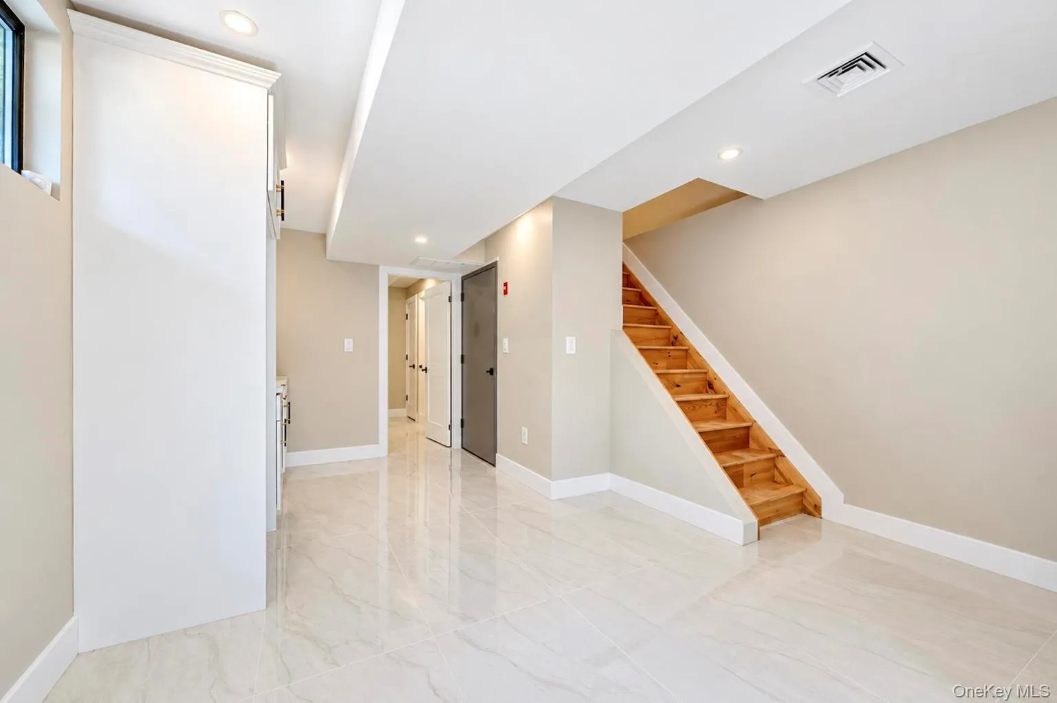 basement Recessed lighting, light-toned walls, and polished tile flooring basement Recessed lighting, light-toned walls, and polished tile flooring
