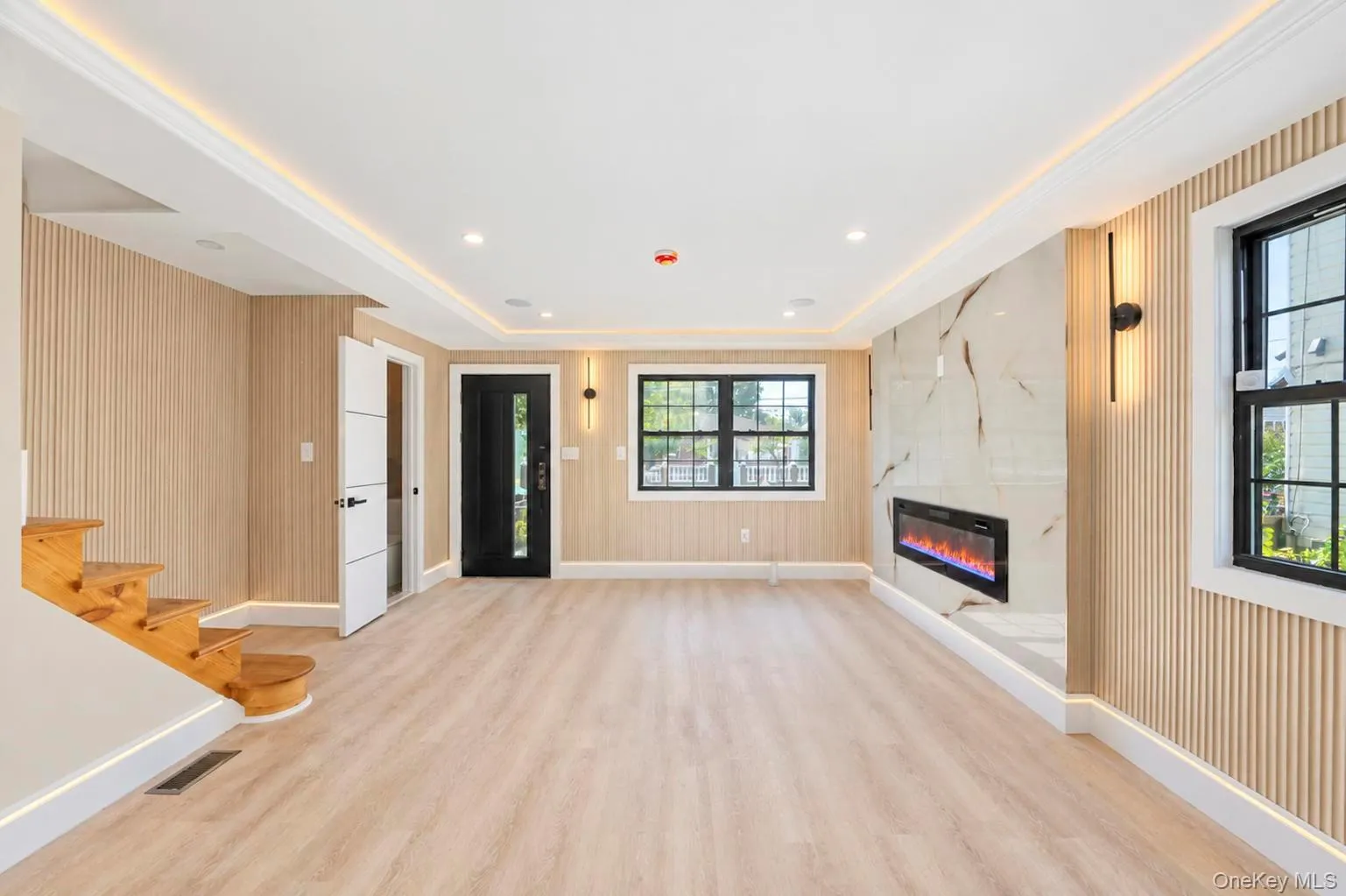 Recessed lighting and cove lighting illuminate wood-finish flooring Recessed lighting and cove lighting illuminate wood-finish flooring