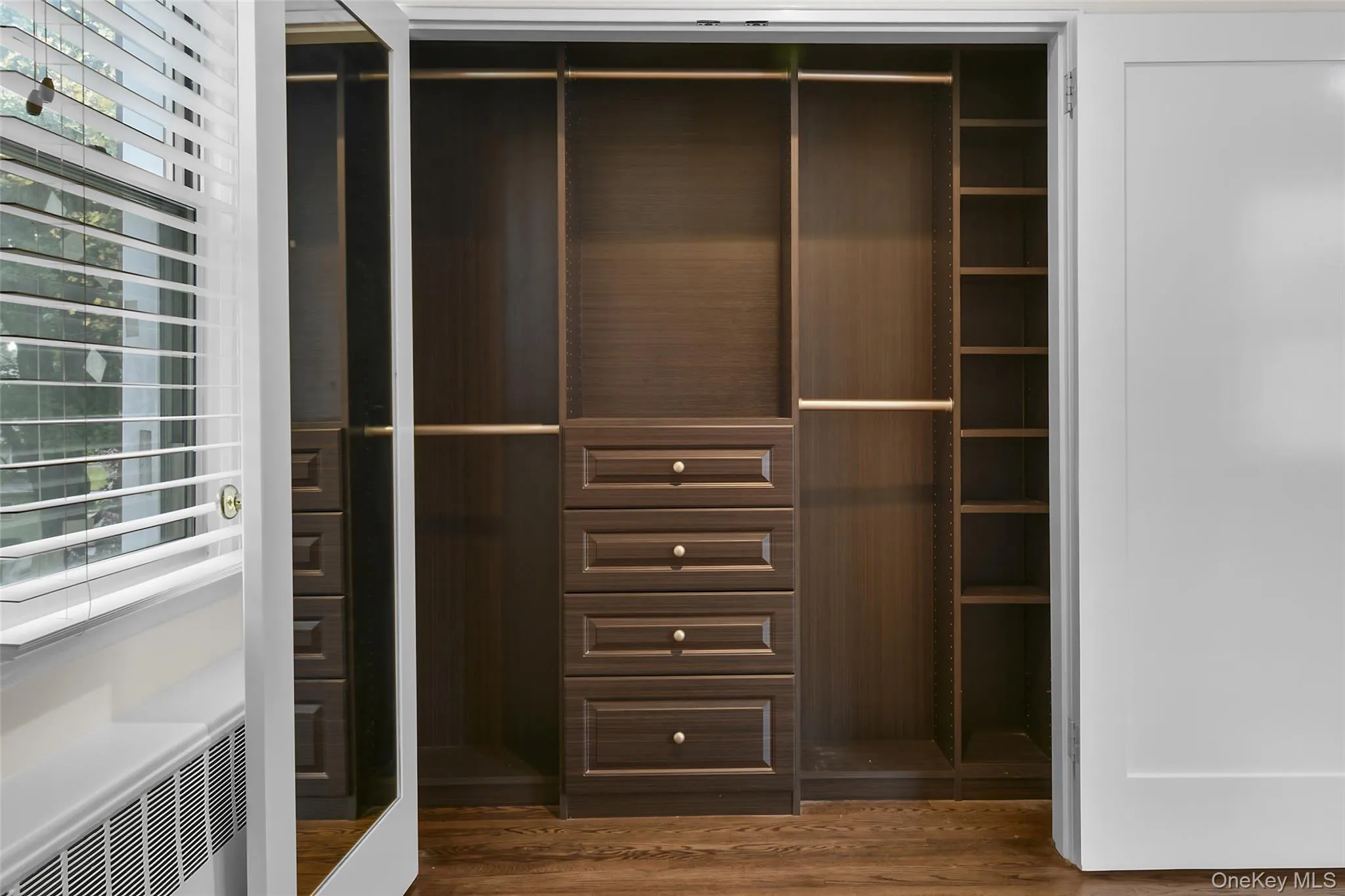 Primary bedroom with a large custom closet. Primary bedroom with a large custom closet.