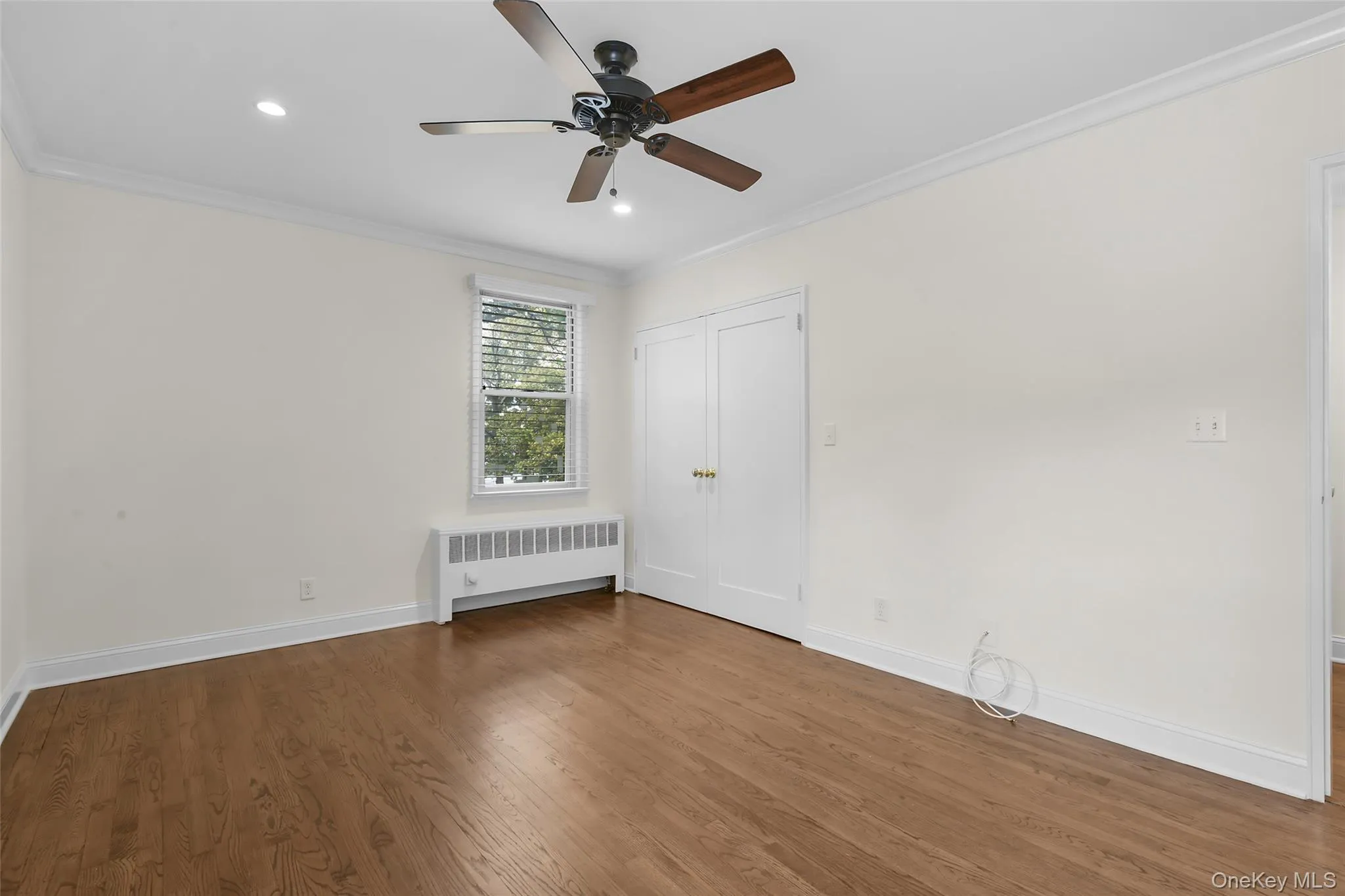 Primary bedroom with a large custom closet. Primary bedroom with a large custom closet.