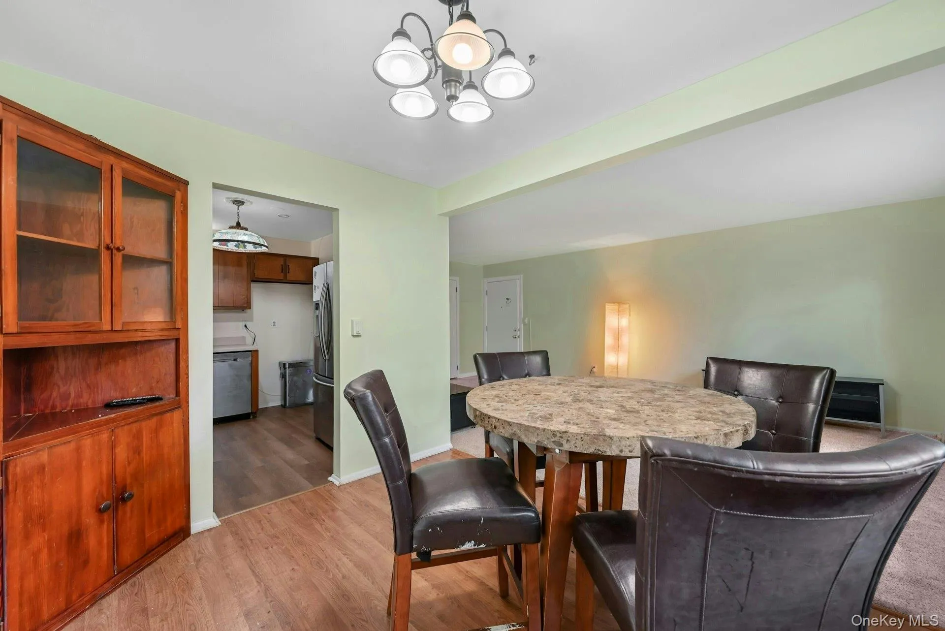 Dining room featuring light wood-style flooring and a chandelier Dining room featuring light wood-style flooring and a chandelier