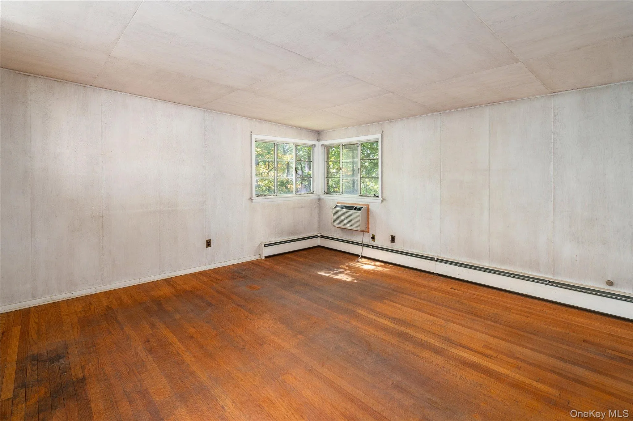 Corner windows open the primary bedroom to the woods Corner windows open the primary bedroom to the woods