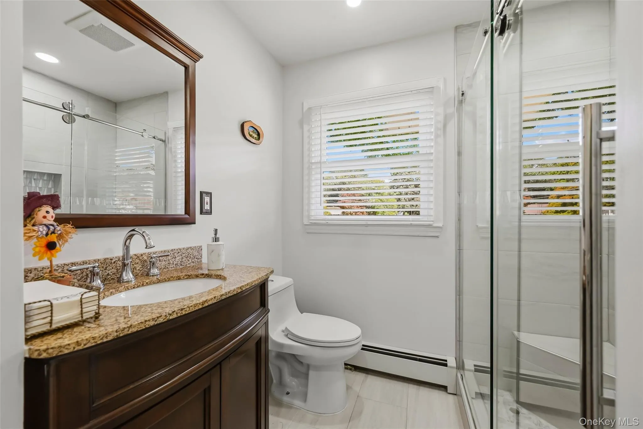 Dark wood-finish vanity with a granite countertop, undermount sink, and chrome faucet Dark wood-finish vanity with a granite countertop, undermount sink, and chrome faucet