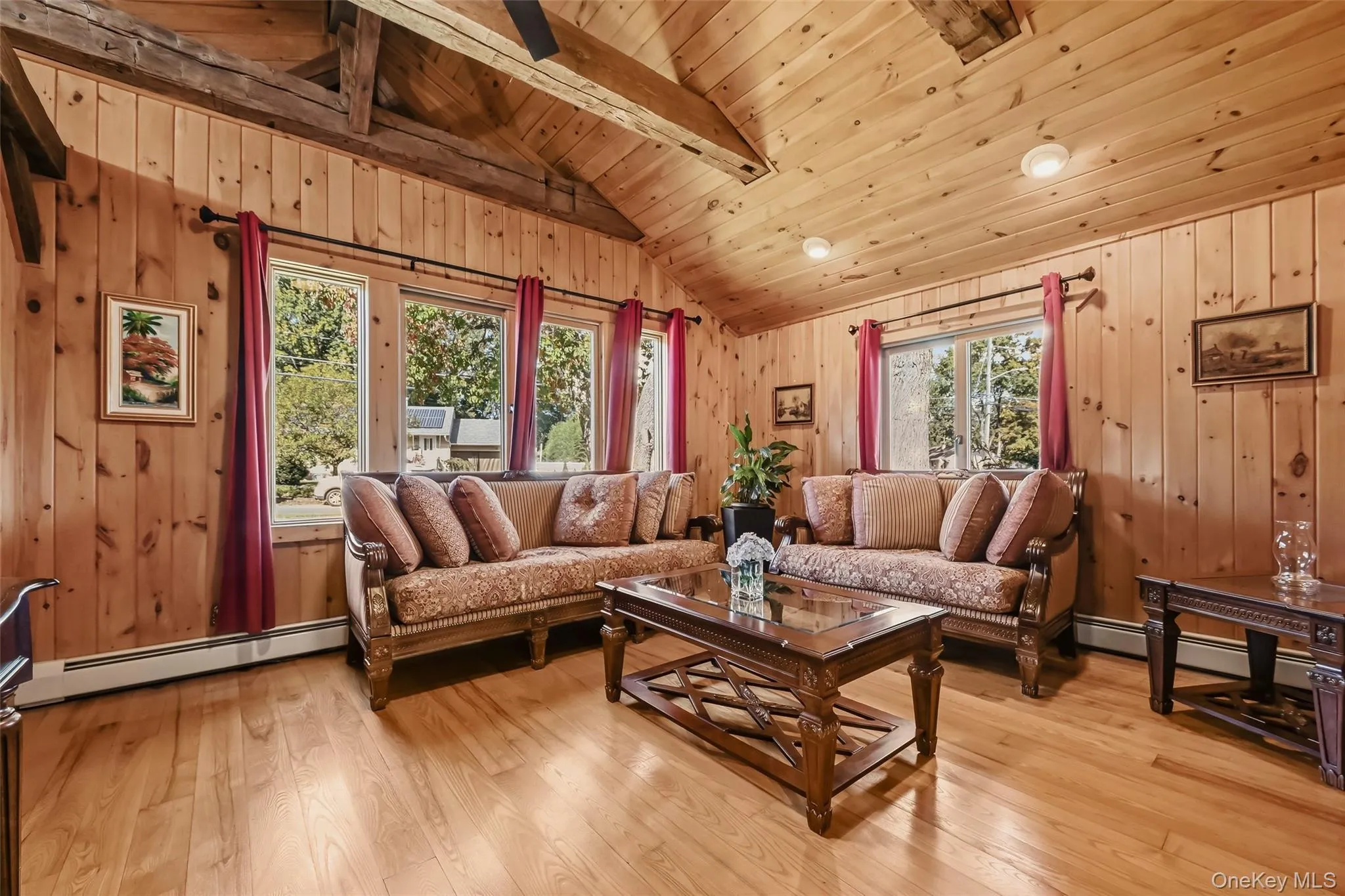 Vaulted wood-finish ceilings with exposed beams, recessed lighting, wood-finish paneling, and wood-finish flooring Vaulted wood-finish ceilings with exposed beams, recessed lighting, wood-finish paneling, and wood-finish flooring