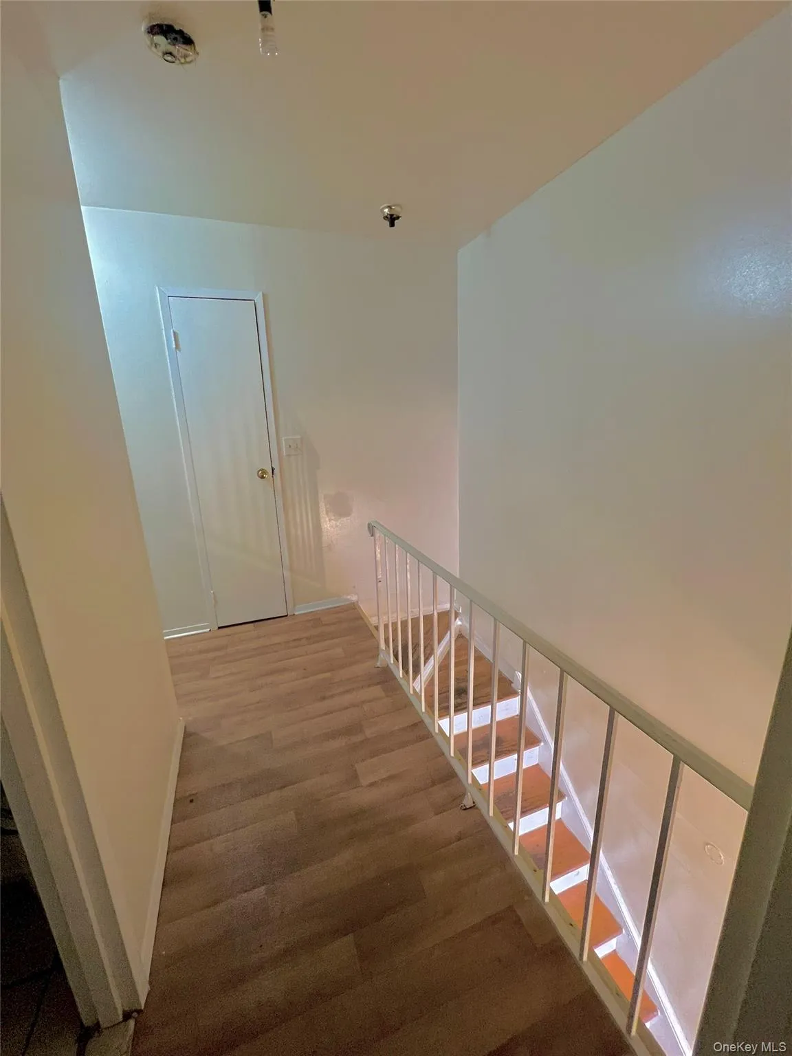 Staircase featuring wood finished floors and baseboards Staircase featuring wood finished floors and baseboards