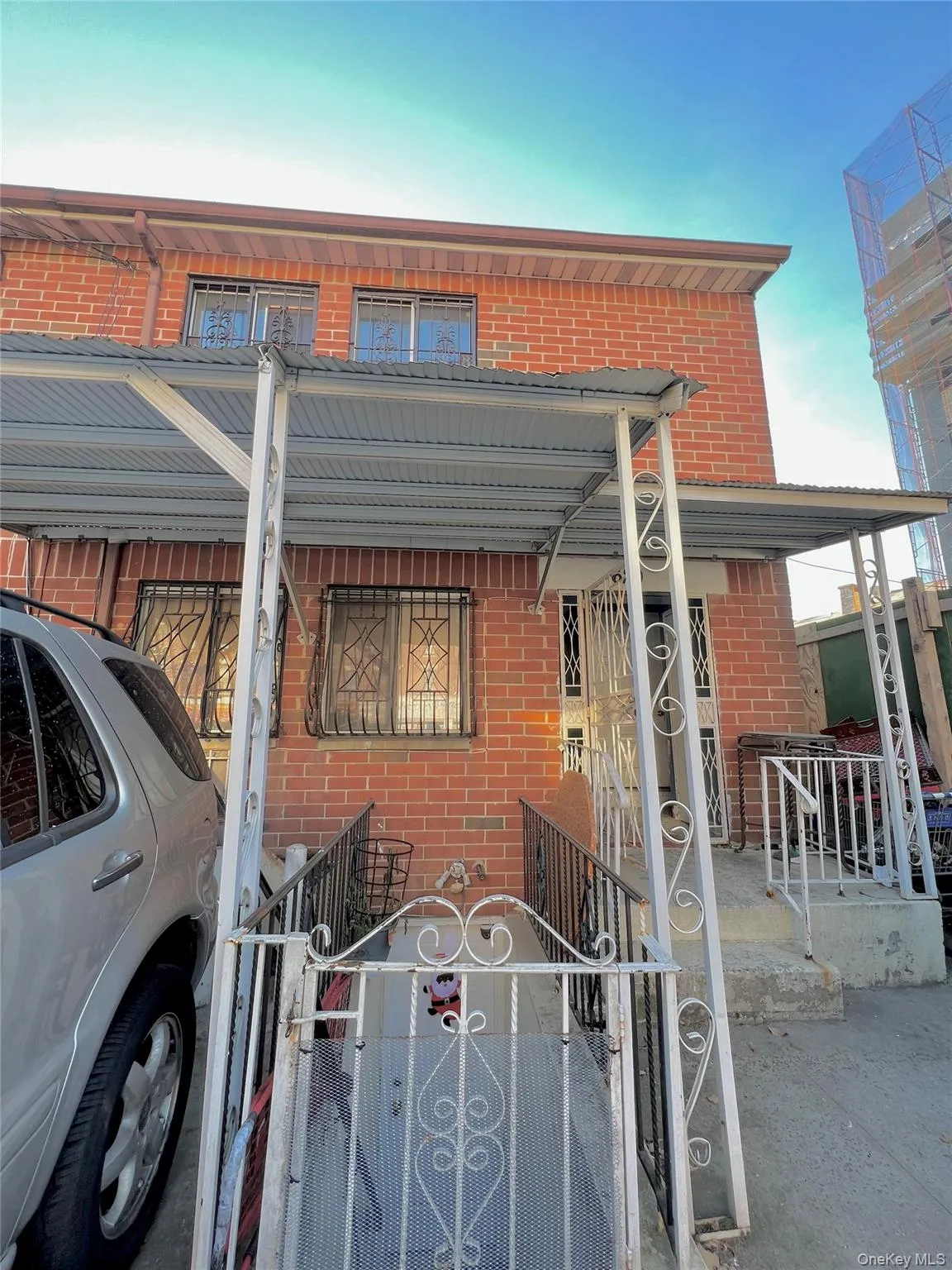 View of front of home featuring brick siding, a porch, a fenced front yard, and a gate View of front of home featuring brick siding, a porch, a fenced front yard, and a gate
