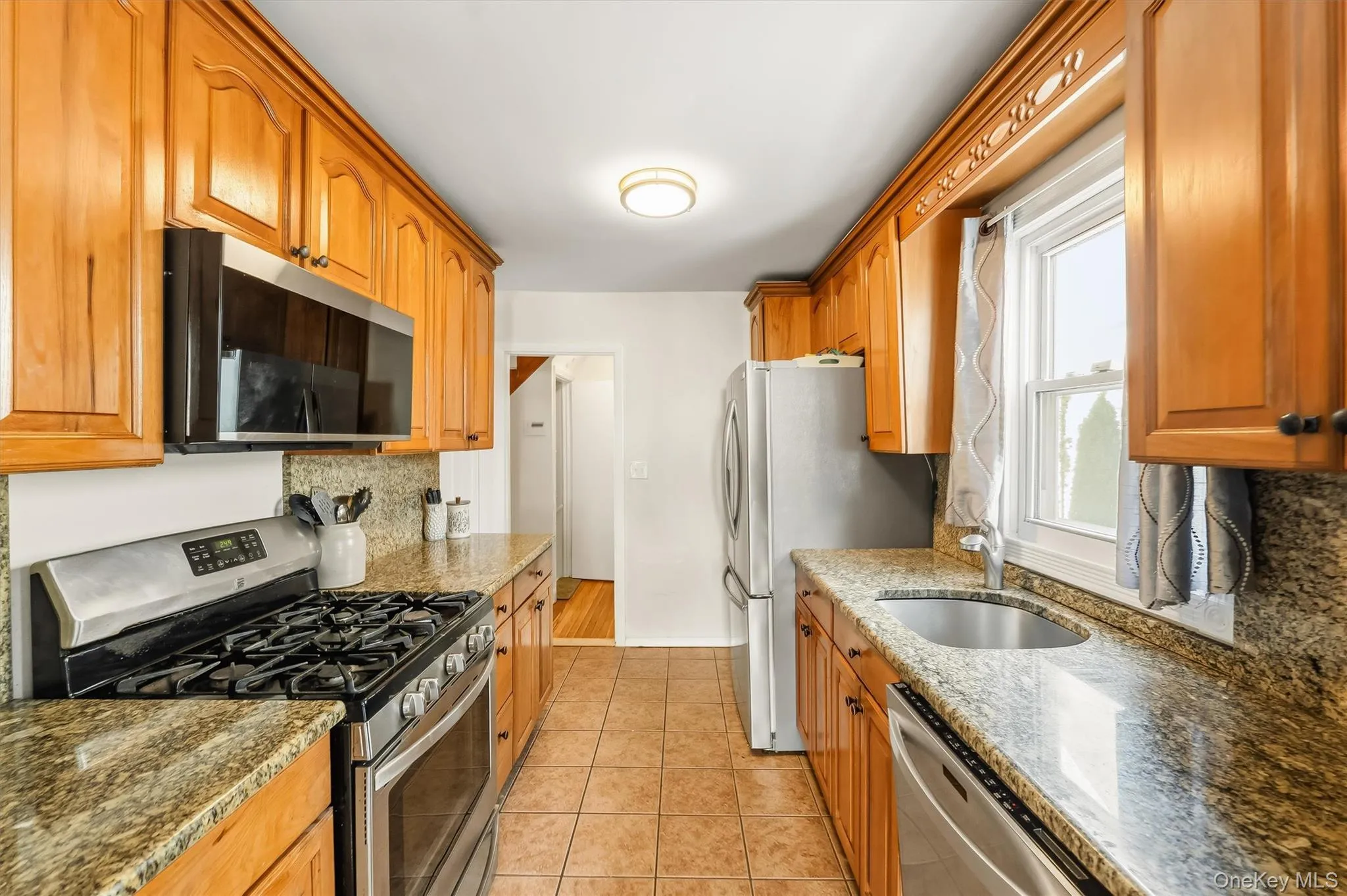 A practical galley layout pairs warm finishes with everyday functionality. A practical galley layout pairs warm finishes with everyday functionality.