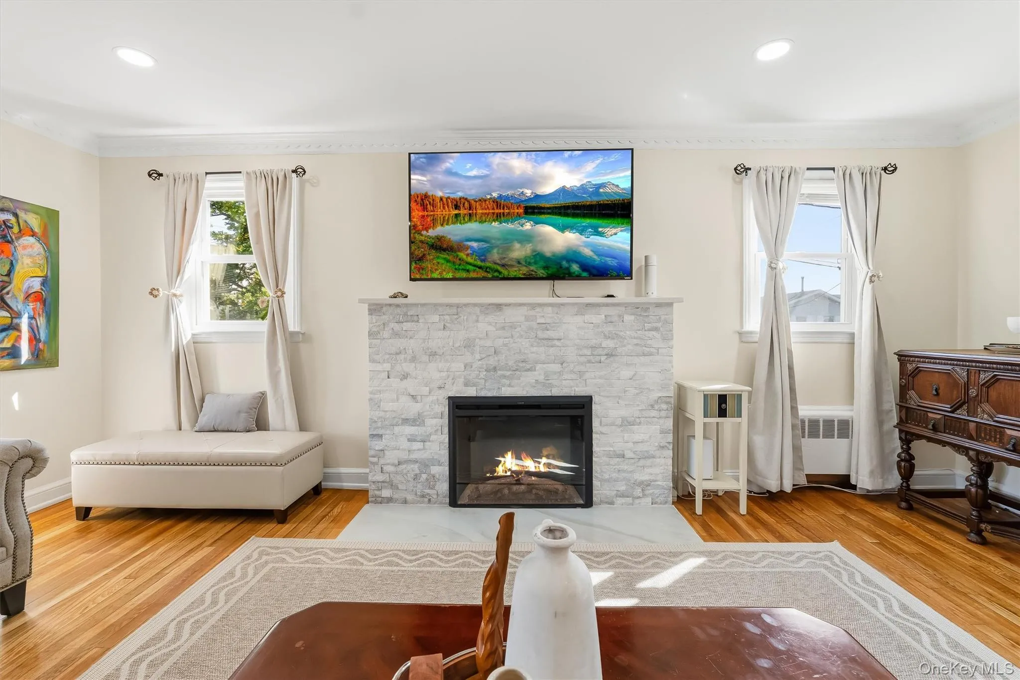 Rich hardwood flooring and classic moldings complement the clean, modern look of the stone fireplace. Rich hardwood flooring and classic moldings complement the clean, modern look of the stone fireplace.