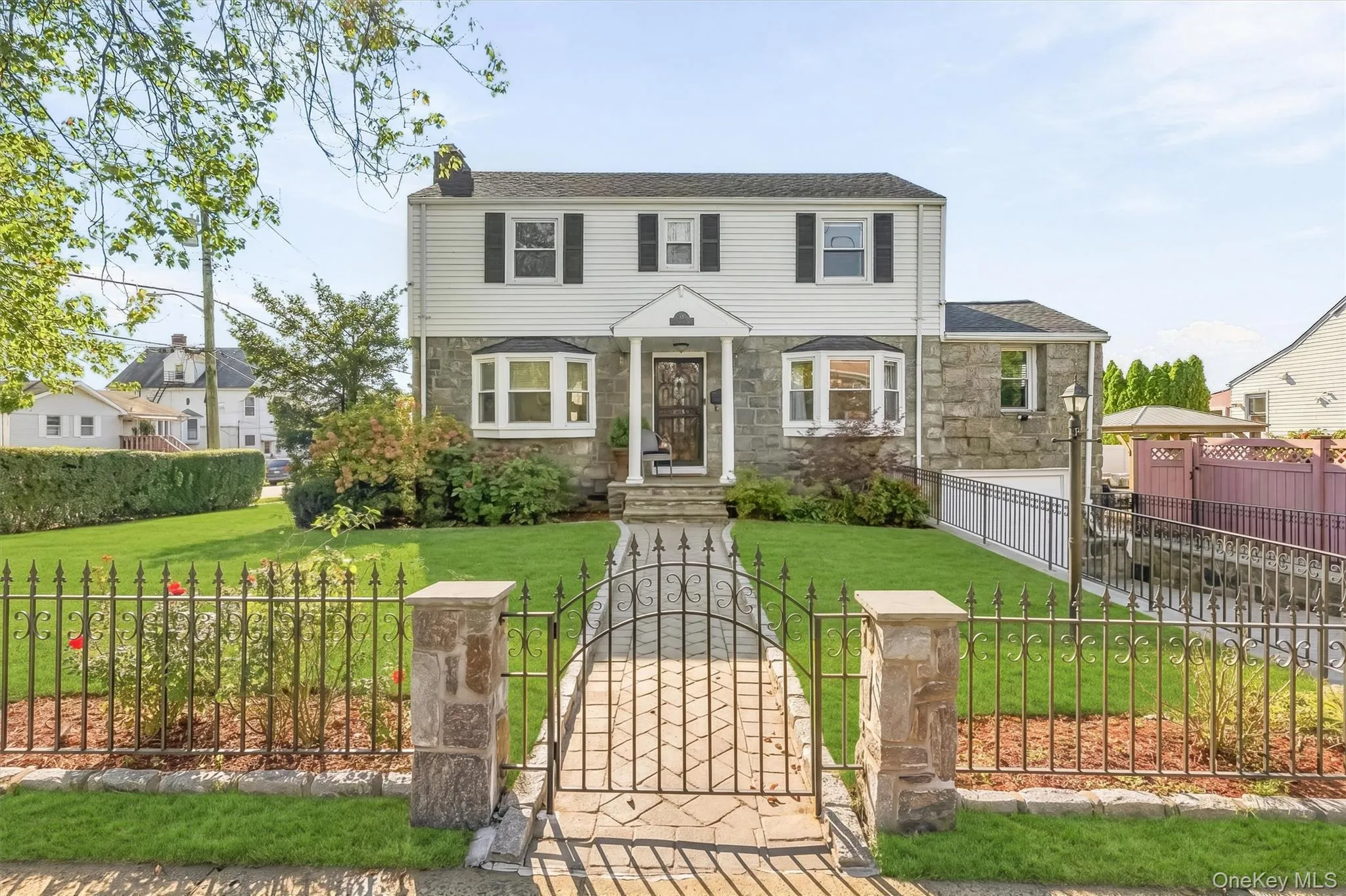 Elegant bay windows, gated privacy, and a welcoming portico distinguish this charming corner property. Elegant bay windows, gated privacy, and a welcoming portico distinguish this charming corner property.