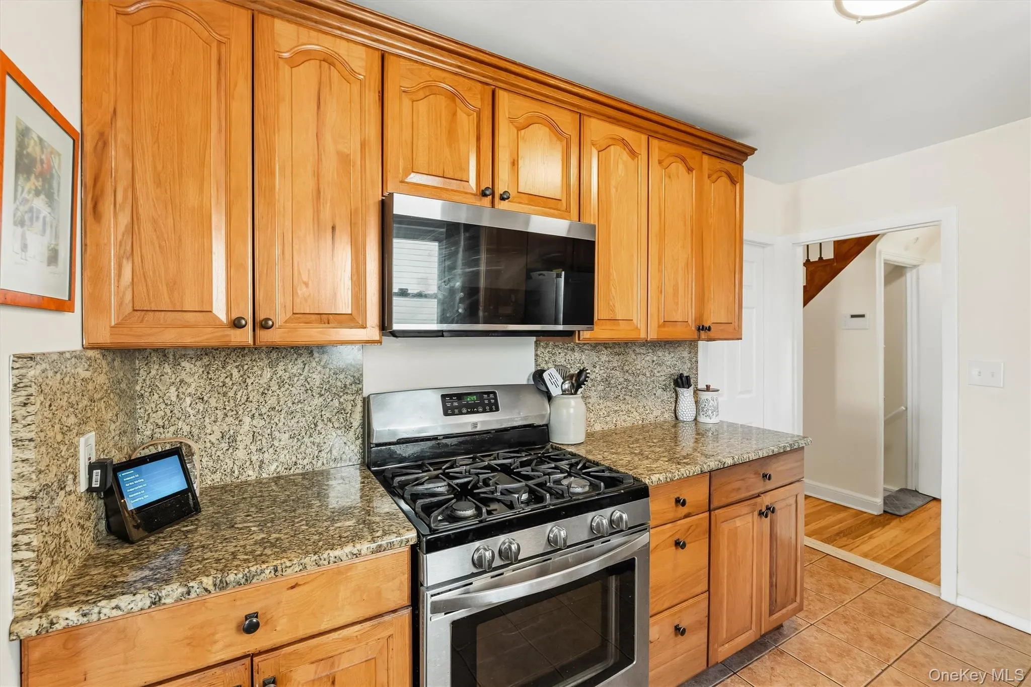 Rich wood tones, granite finishes, and modern appliances make this kitchen both inviting and functional. Rich wood tones, granite finishes, and modern appliances make this kitchen both inviting and functional.