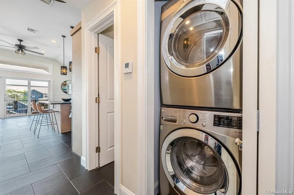 Laundry area featuring stacked washer / dryer Laundry area featuring stacked washer / dryer