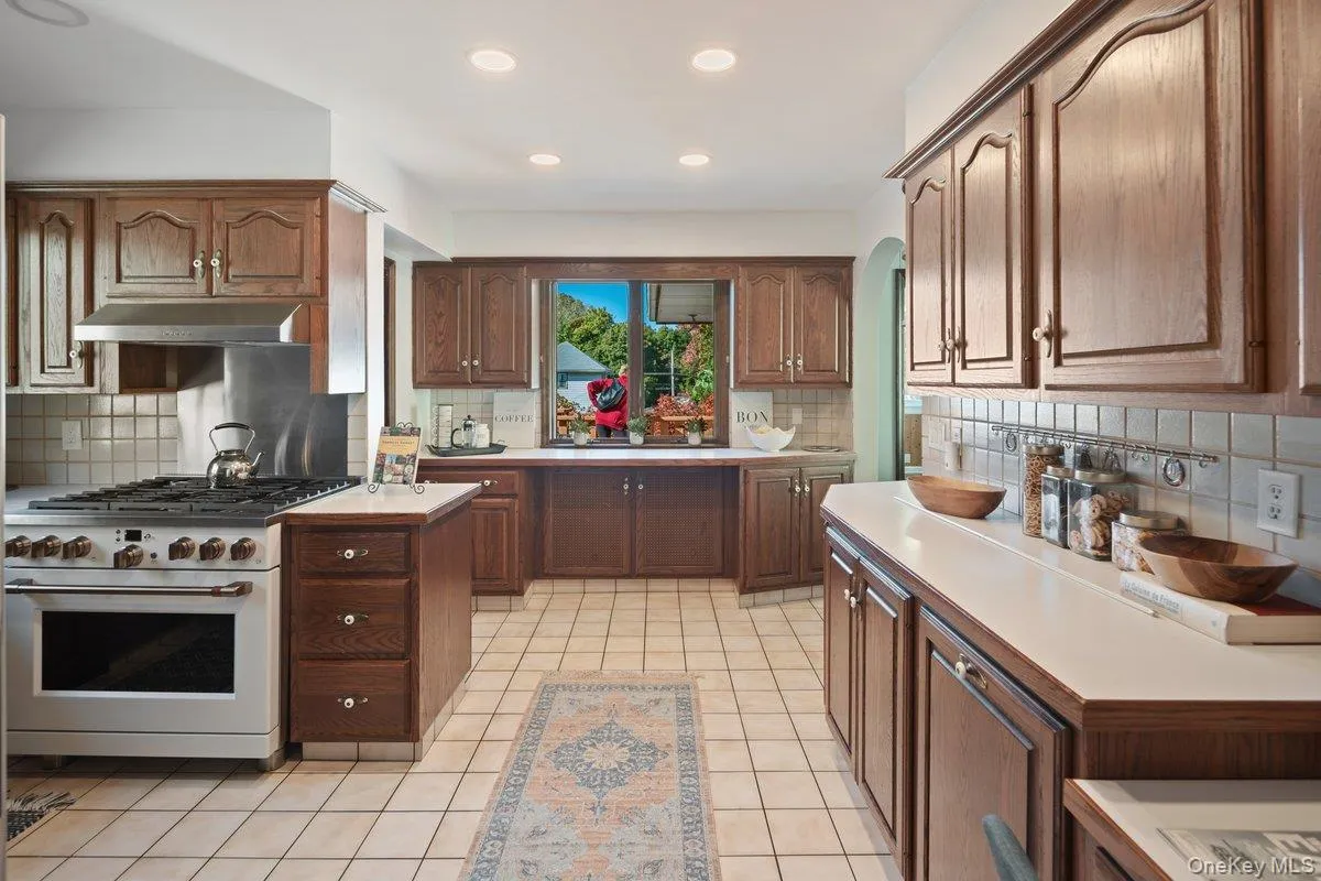The generously sized kitchen is a chef’s delight, offering an abundance of cabinets, ample counter space, and plenty of natural light. The generously sized kitchen is a chef’s delight, offering an abundance of cabinets, ample counter space, and plenty of natural light.