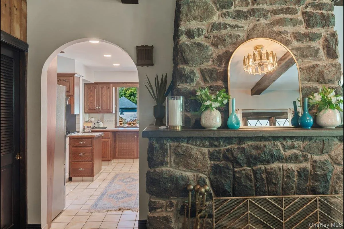 An original fireplace paired with modern lighting creates a stunning blend of two worlds. An original fireplace paired with modern lighting creates a stunning blend of two worlds.