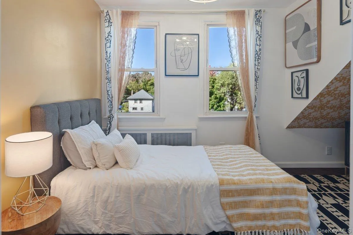 Second bedroom with dual windows overlooking the backyard and offering winter river views. Second bedroom with dual windows overlooking the backyard and offering winter river views.