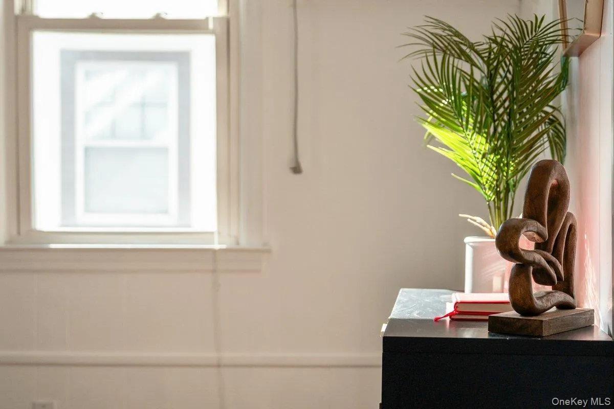 Sunlight streams into the second-floor landing, which houses the bedrooms, full bath, hall closets, and attic access. Sunlight streams into the second-floor landing, which houses the bedrooms, full bath, hall closets, and attic access.
