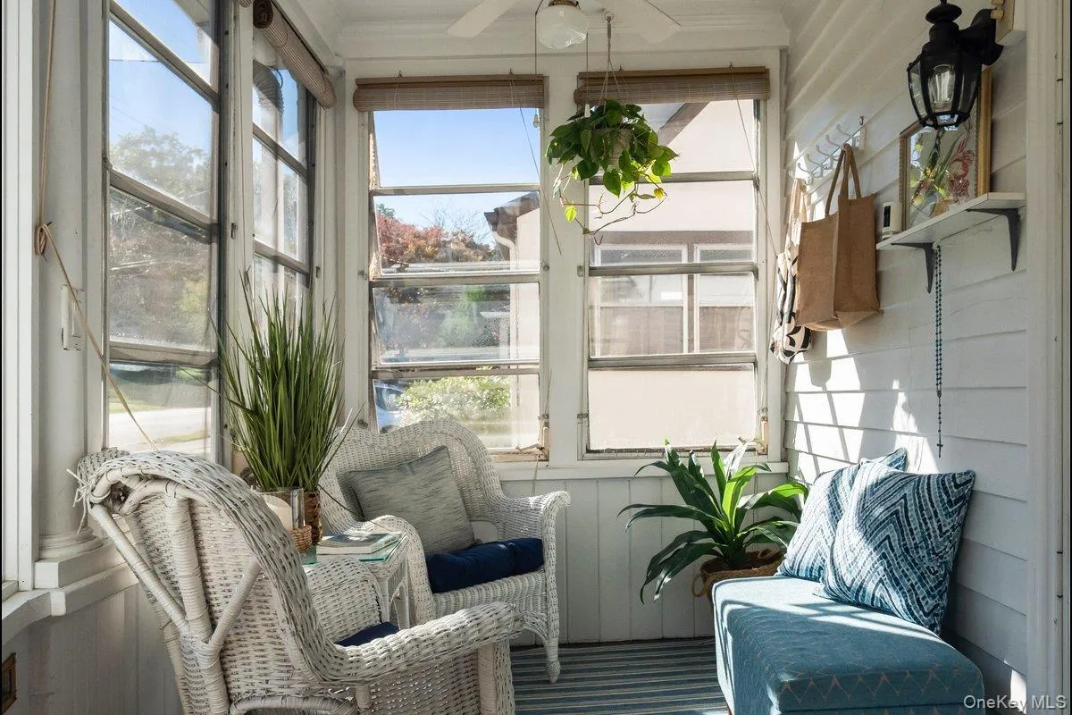 Upon entering, you're welcomed by a bright, fully enclosed heated front sun porch that also serves as a mudroom. It's the ideal spot to unwind and enjoy the charming neighborhood views. Upon entering, you're welcomed by a bright, fully enclosed heated front sun porch that also serves as a mudroom. It's the ideal spot to unwind and enjoy the charming neighborhood views.