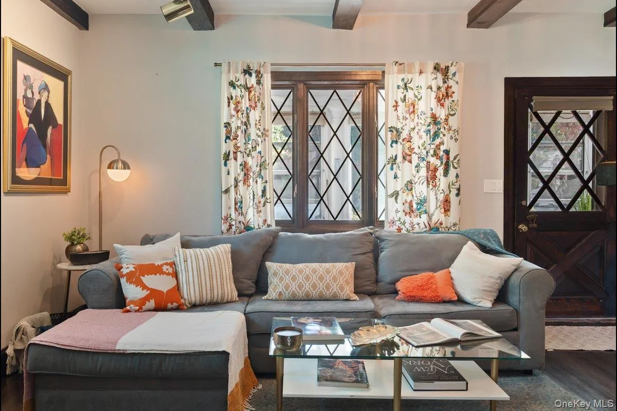 The diamond-pane leaded glass windows provide views of the sun porch and let in natural sunlight, while the original Dutch wood entry door with diamond-patterned wood window insets adds to the home's charming details. The diamond-pane leaded glass windows provide views of the sun porch and let in natural sunlight, while the original Dutch wood entry door with diamond-patterned wood window insets adds to the home's charming details.