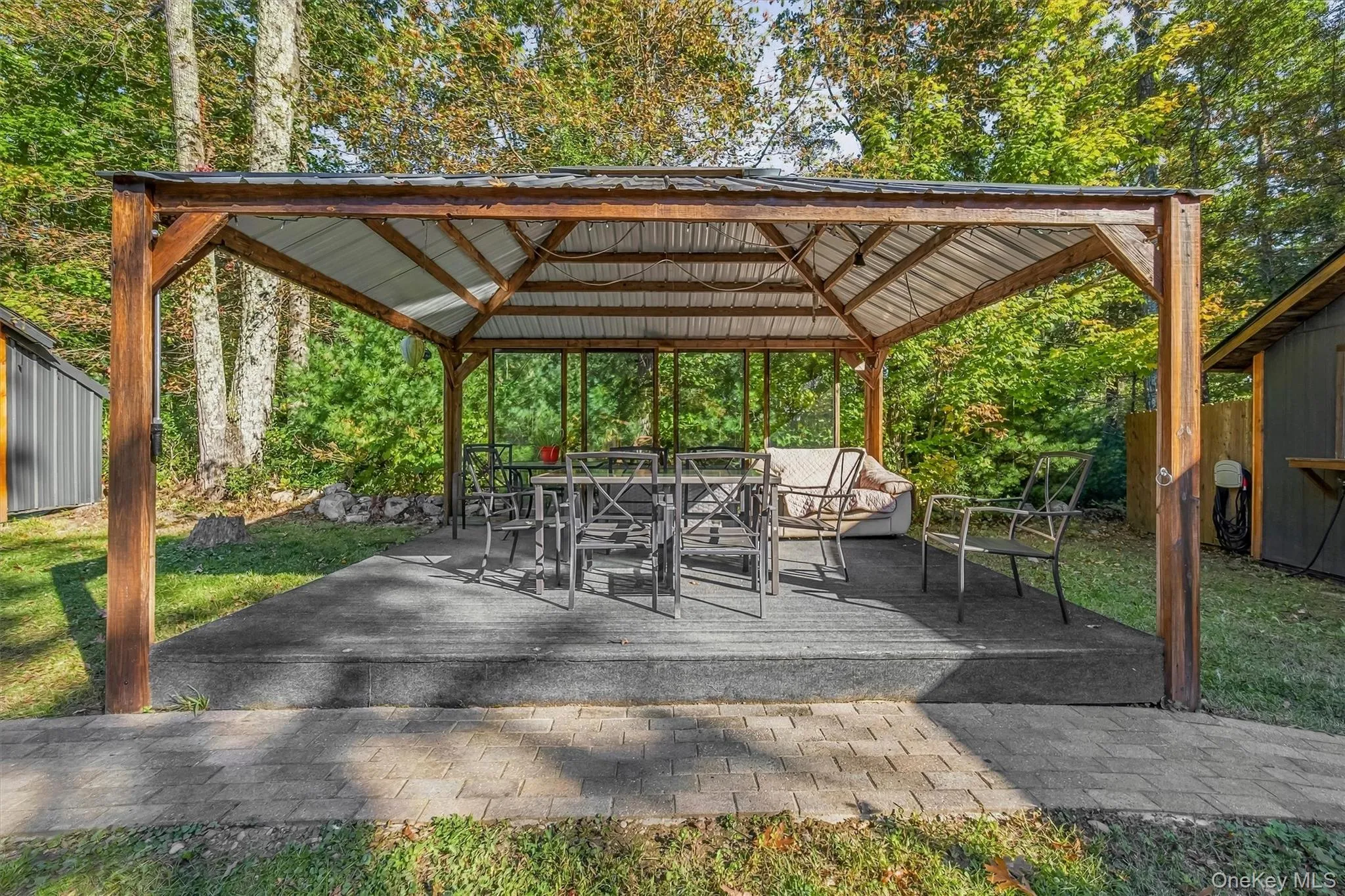 Spacious covered outdoor pavilion with a metal roof for outdoor dining, entertaining,and relaxing Spacious covered outdoor pavilion with a metal roof for outdoor dining, entertaining,and relaxing