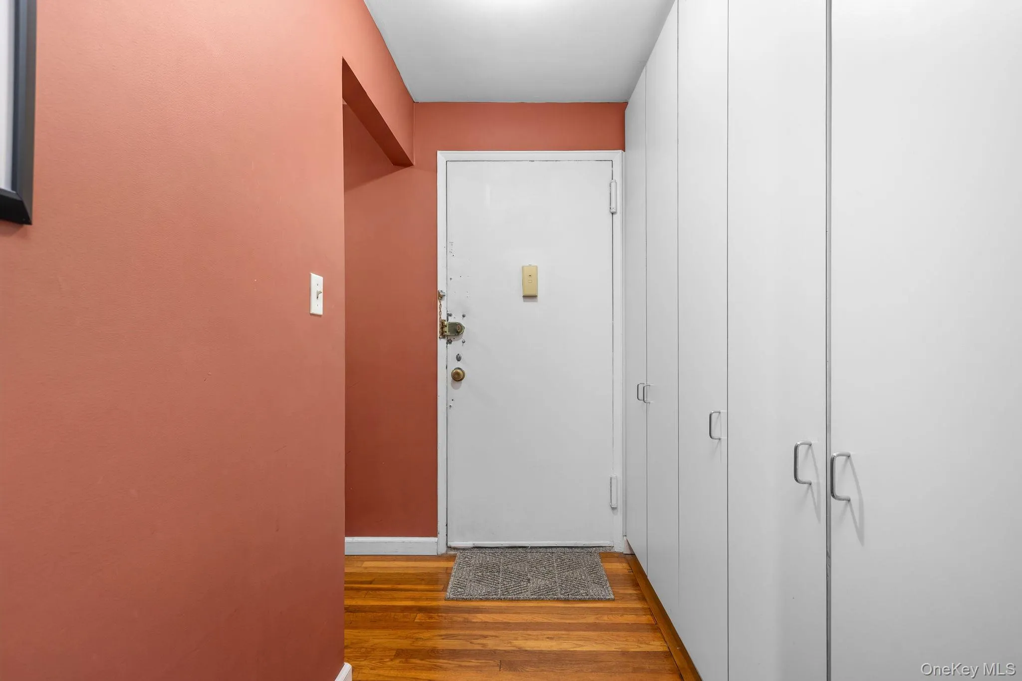 Hardwood flooring throughout, with a solid white entry door Hardwood flooring throughout, with a solid white entry door