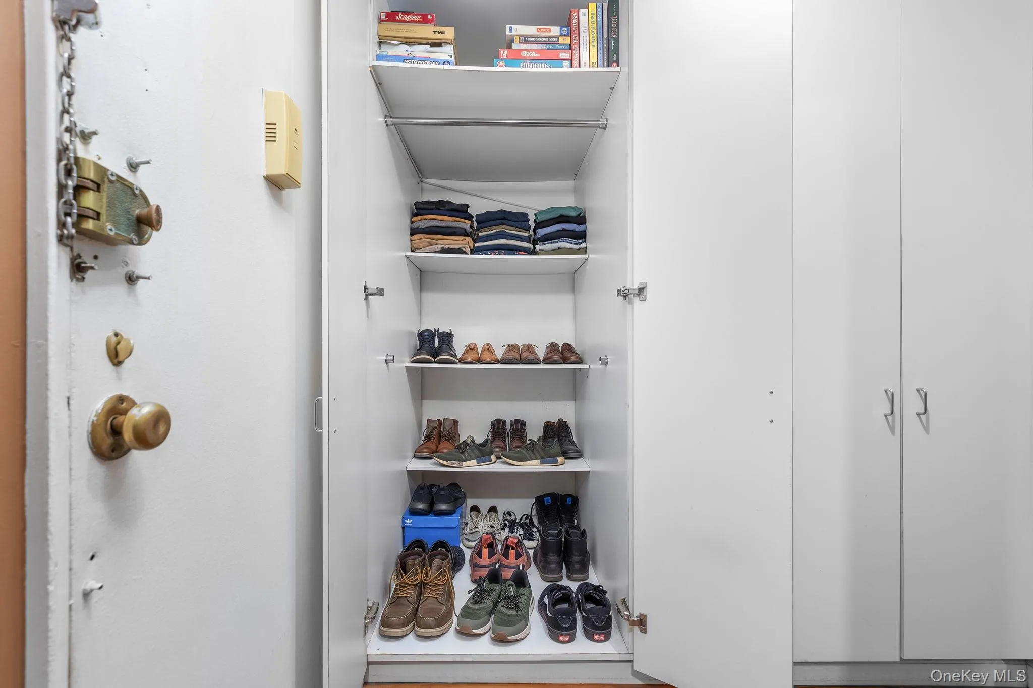 Built-in storage cabinet featuring multiple shelves Built-in storage cabinet featuring multiple shelves