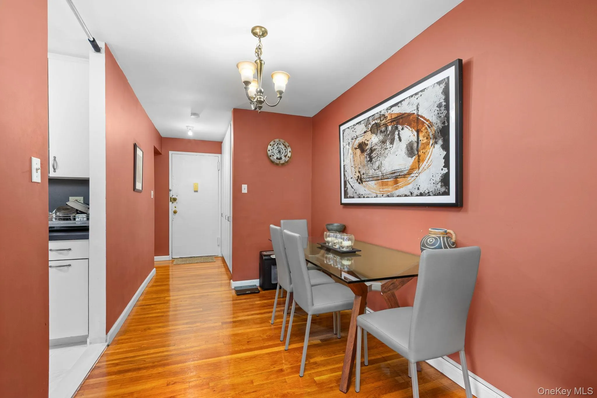 Hardwood-finish flooring, recessed lighting, and a chandelier illuminate the space Hardwood-finish flooring, recessed lighting, and a chandelier illuminate the space