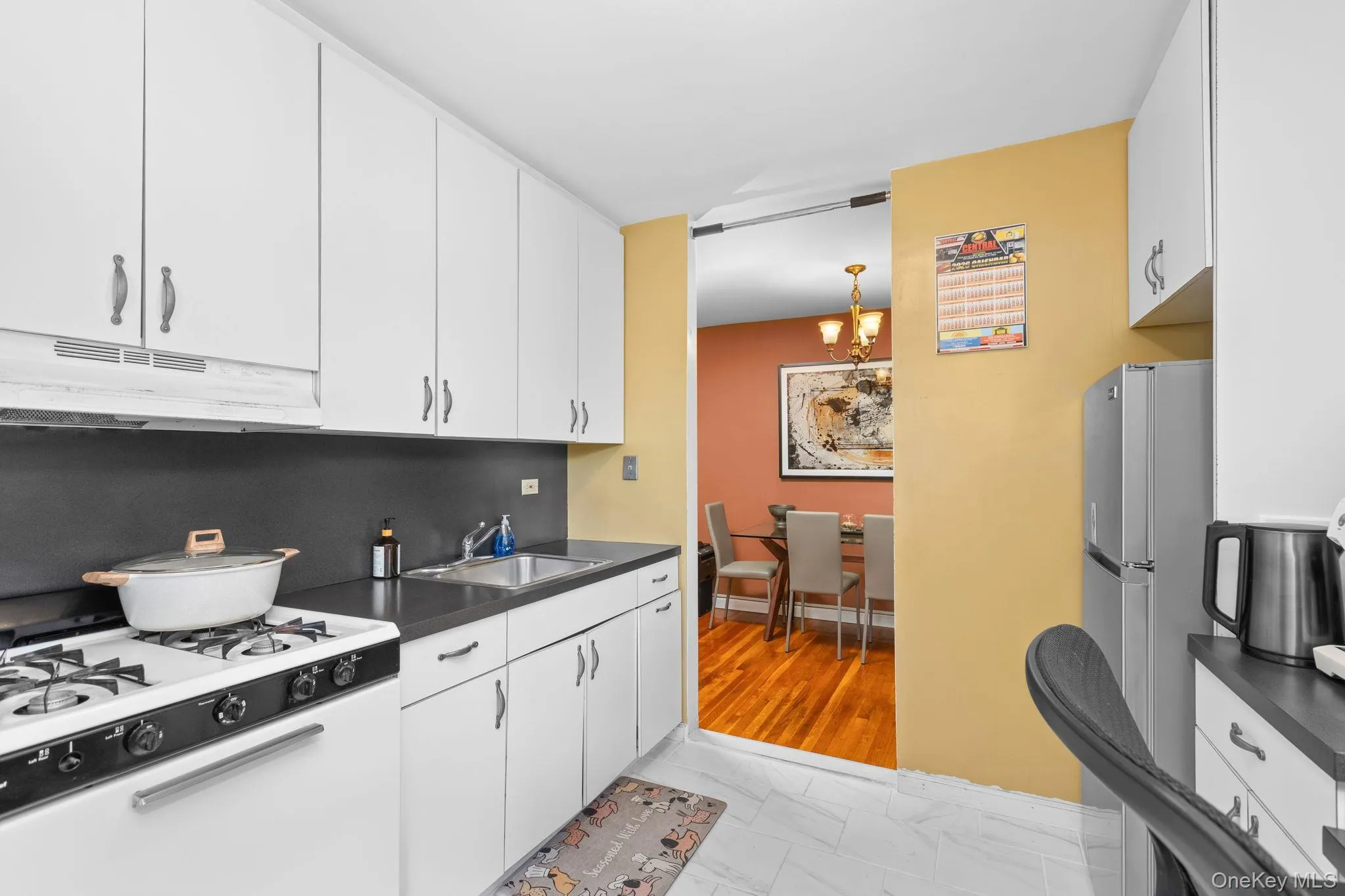 White cabinetry with dark countertops White cabinetry with dark countertops