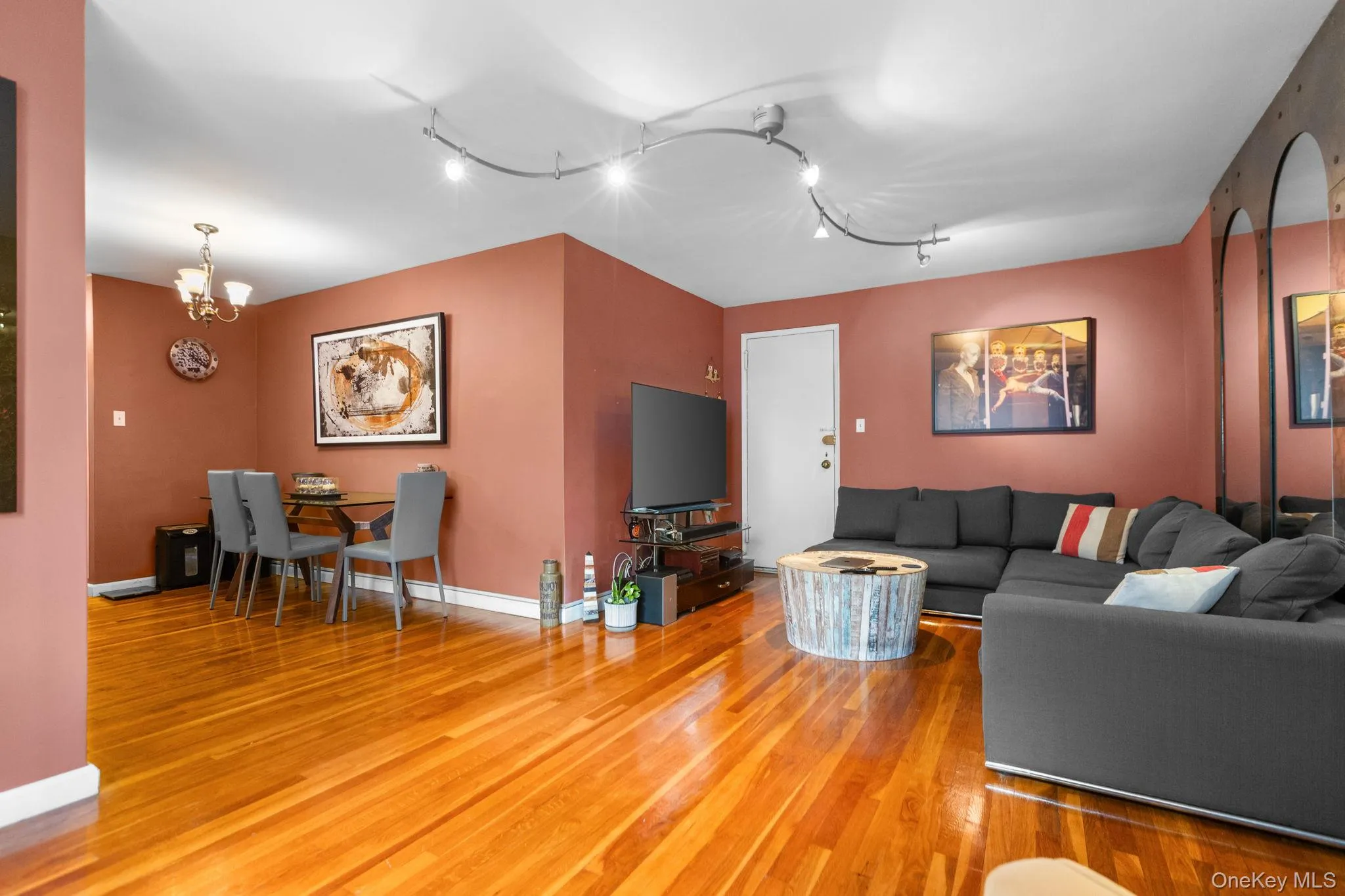 Hardwood flooring throughout, track lighting, and a built-in chandelier Hardwood flooring throughout, track lighting, and a built-in chandelier